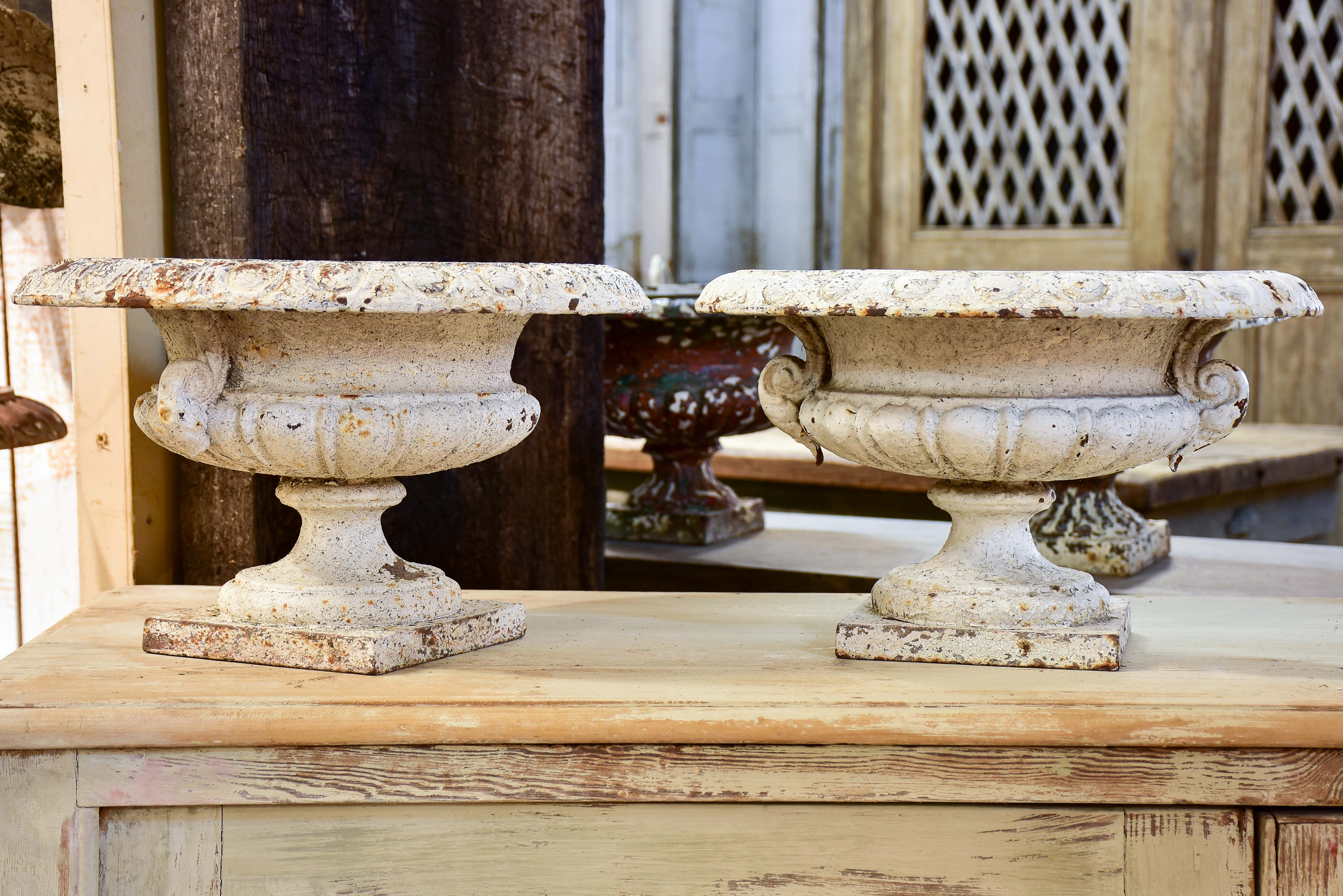 Pair of antique French cast iron garden urns with white patina