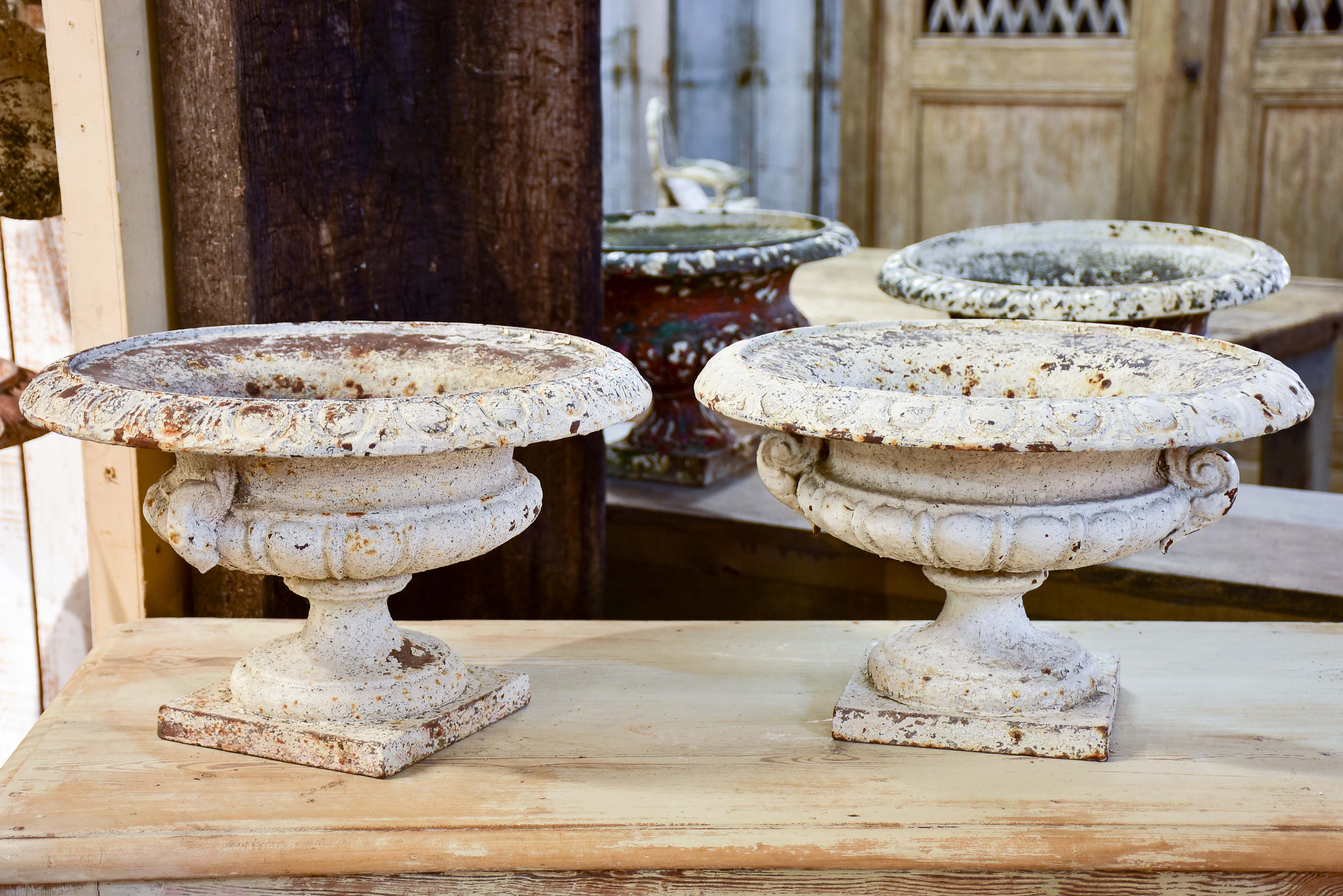 Pair of antique French cast iron garden urns with white patina