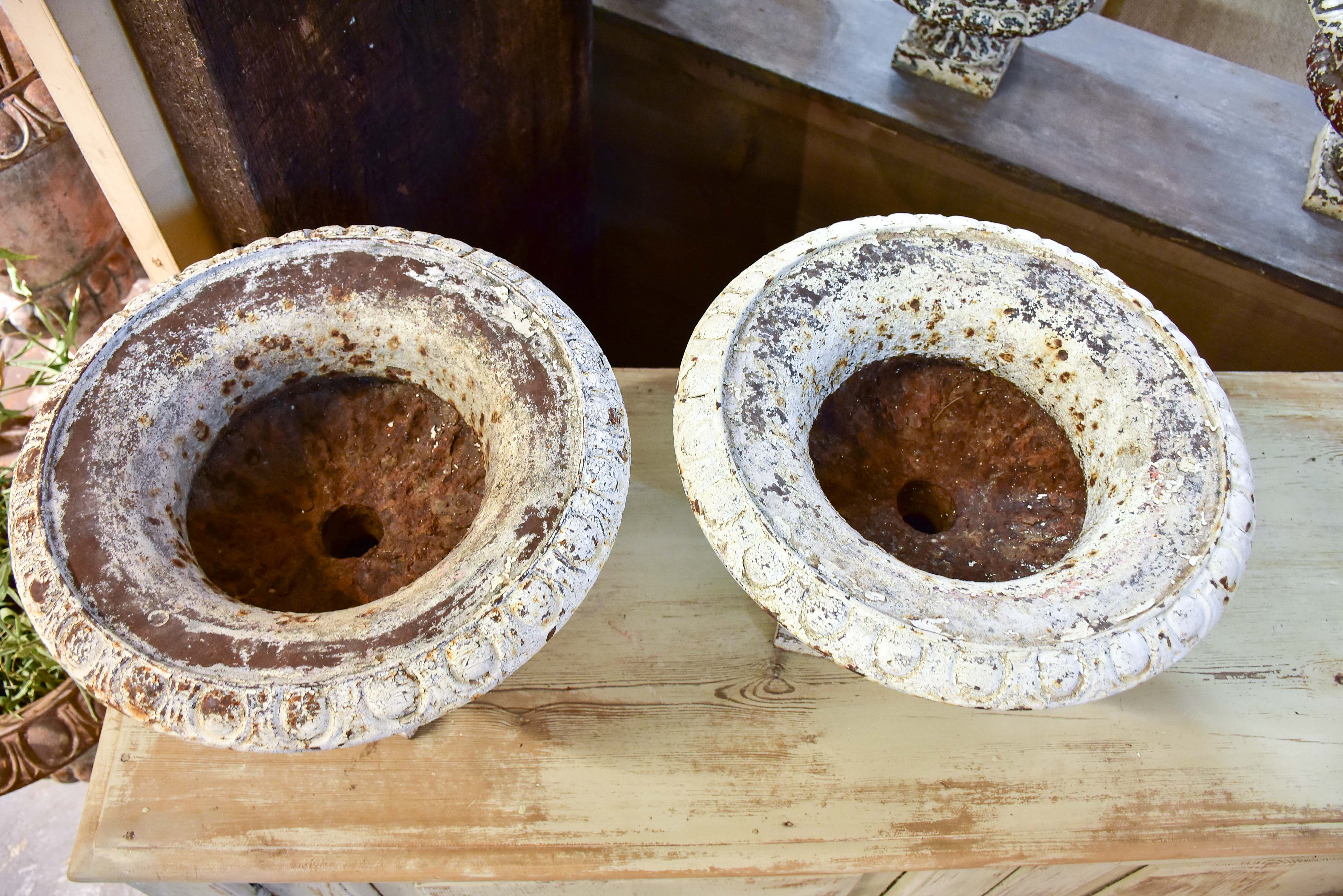 Pair of antique French cast iron garden urns with white patina