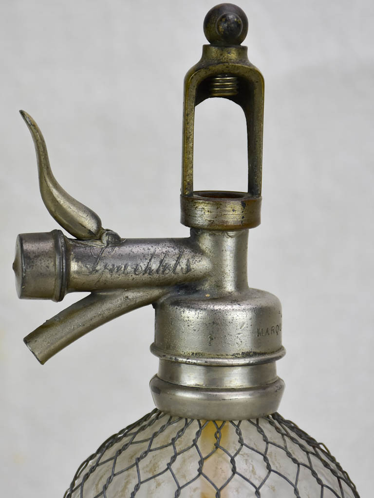 Antique French seltzer bottle in wire