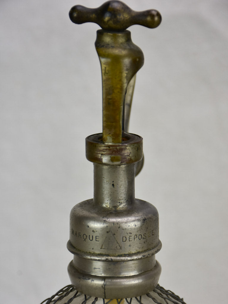 Antique French seltzer bottle in wire