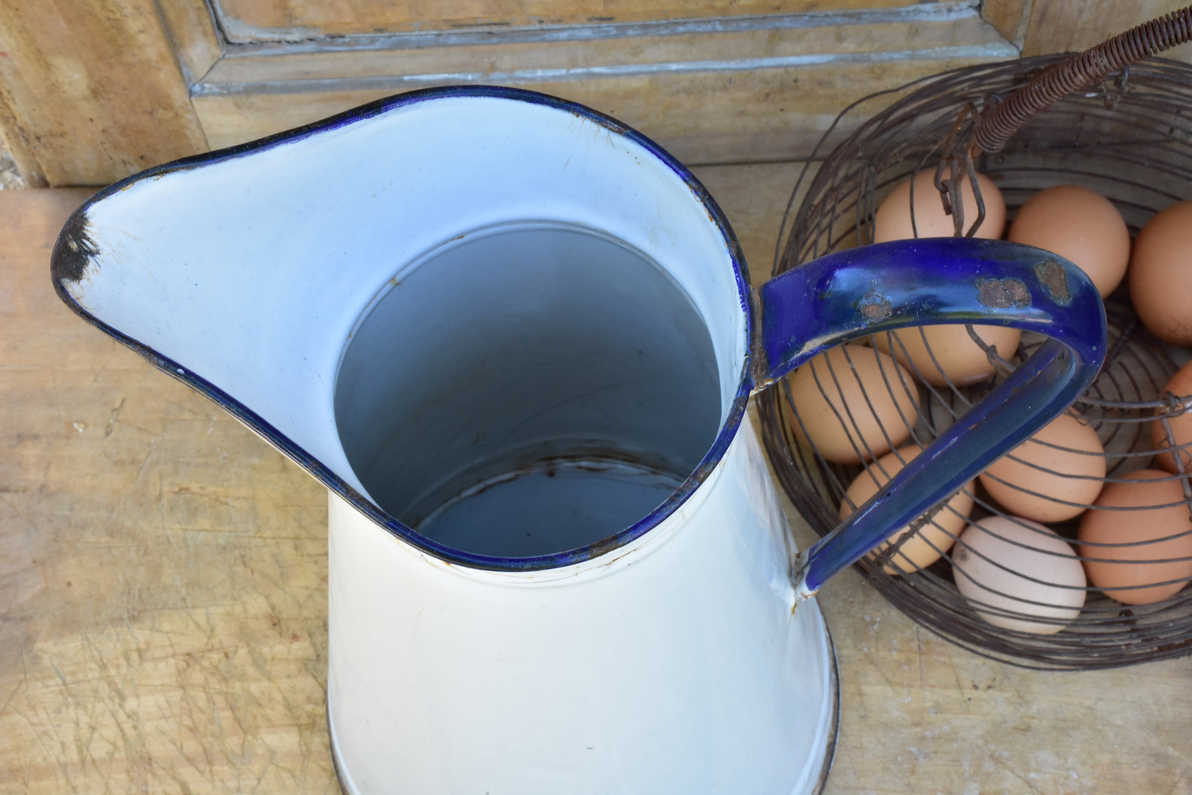 1920's enamel pitcher with blue rim