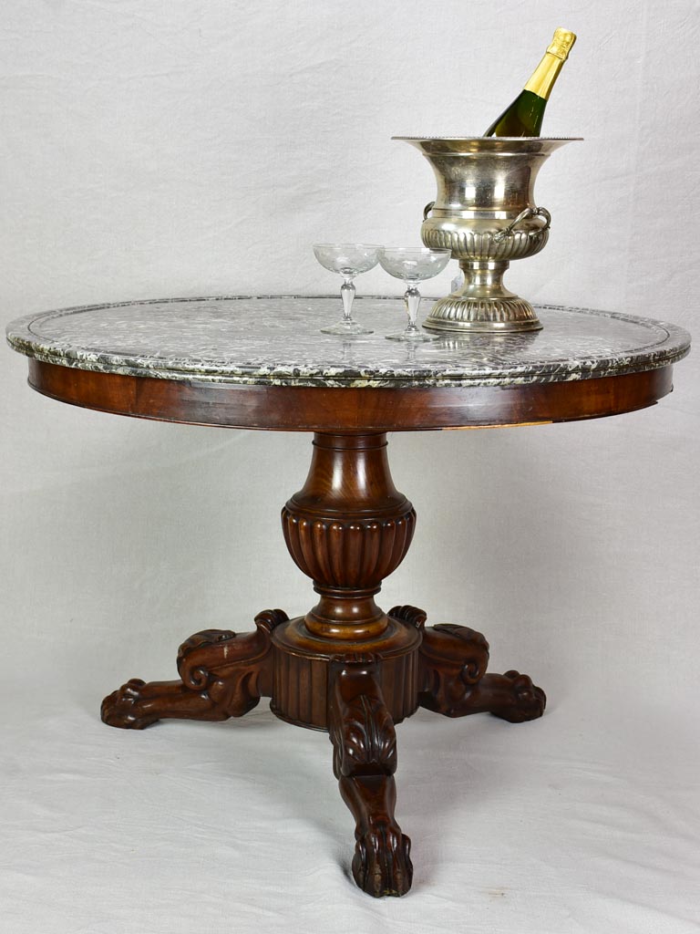 Early twentieth-century Napoleon III round center table with black marble top and claw feet 38¼"