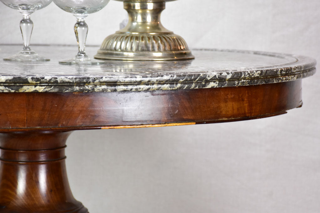 Early twentieth-century Napoleon III round center table with black marble top and claw feet 38¼"