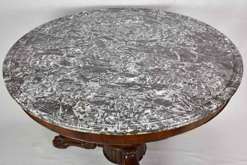 Early twentieth-century Napoleon III round center table with black marble top and claw feet 38¼"