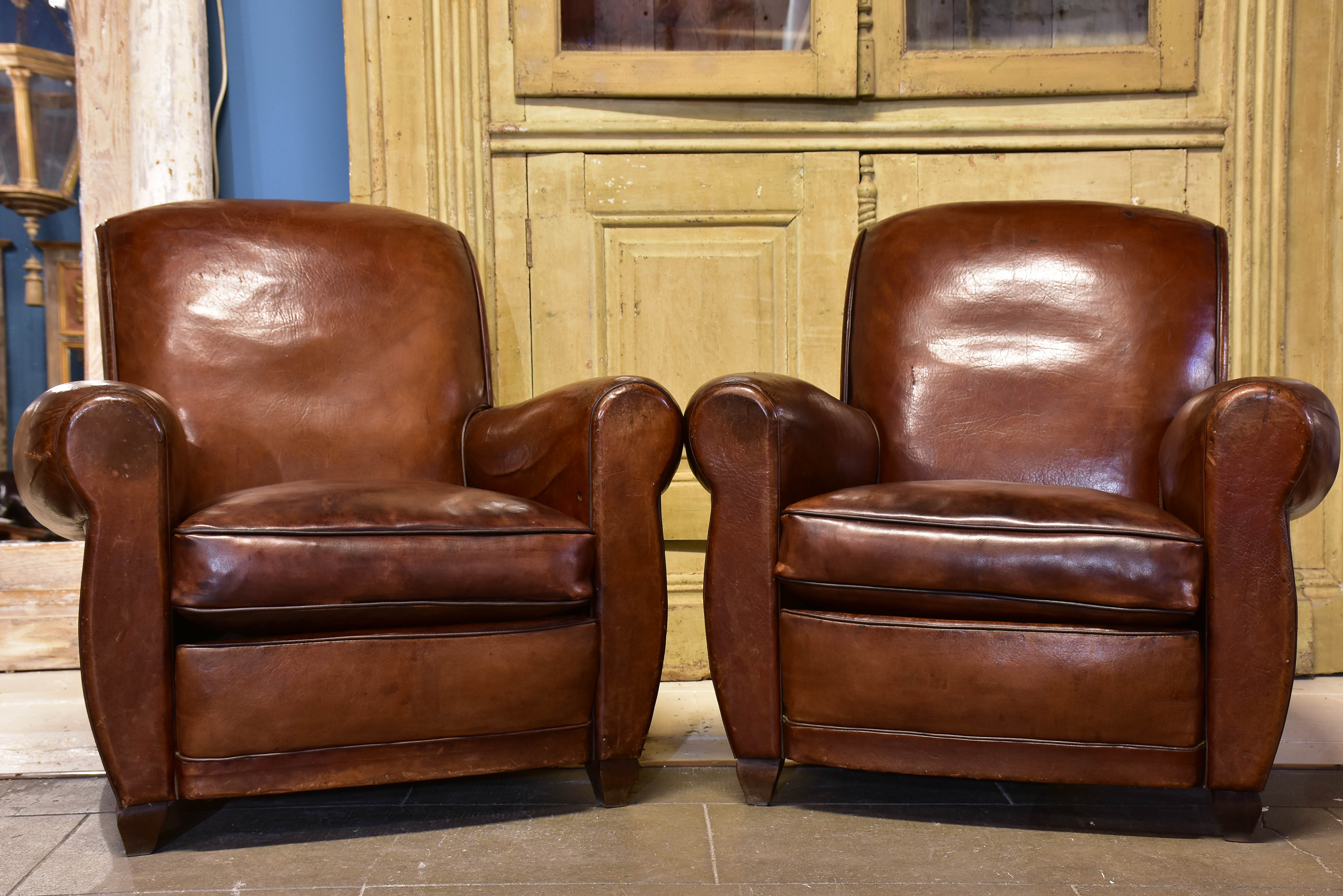 Pair of vintage French brown leather club chairs