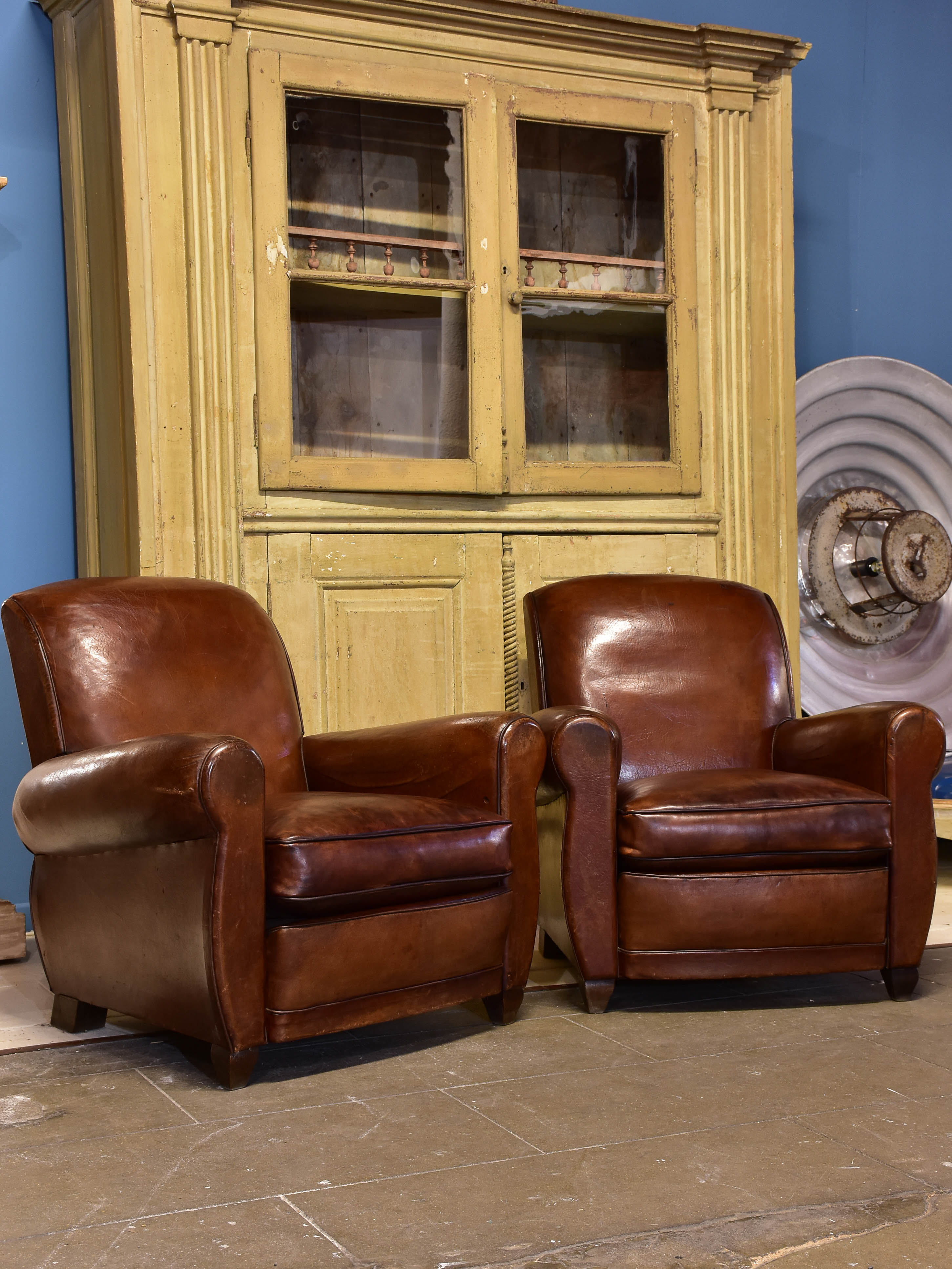 Pair of vintage French brown leather club chairs