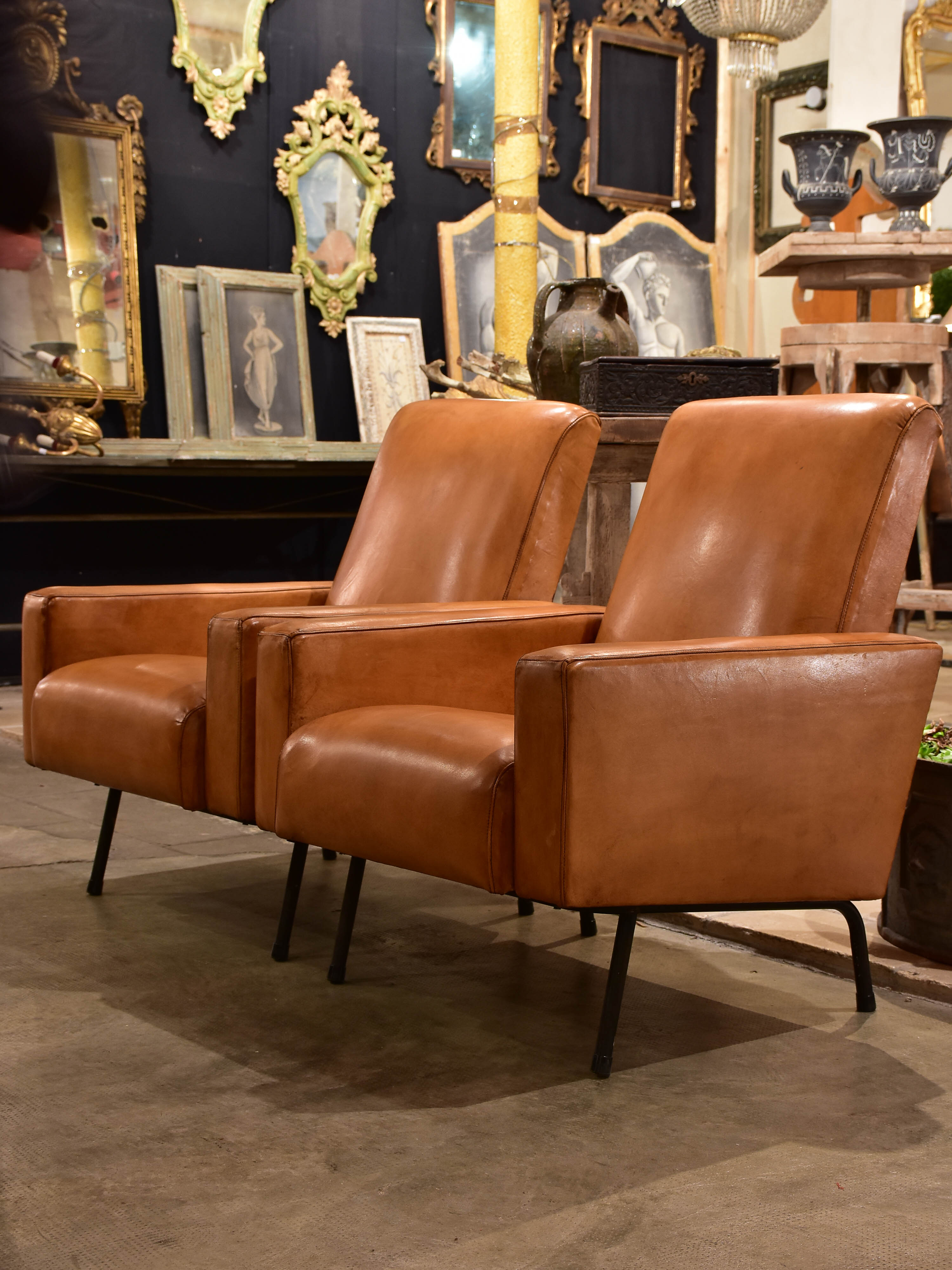 Pair of French leather armchairs in the style of Pierre Guariche