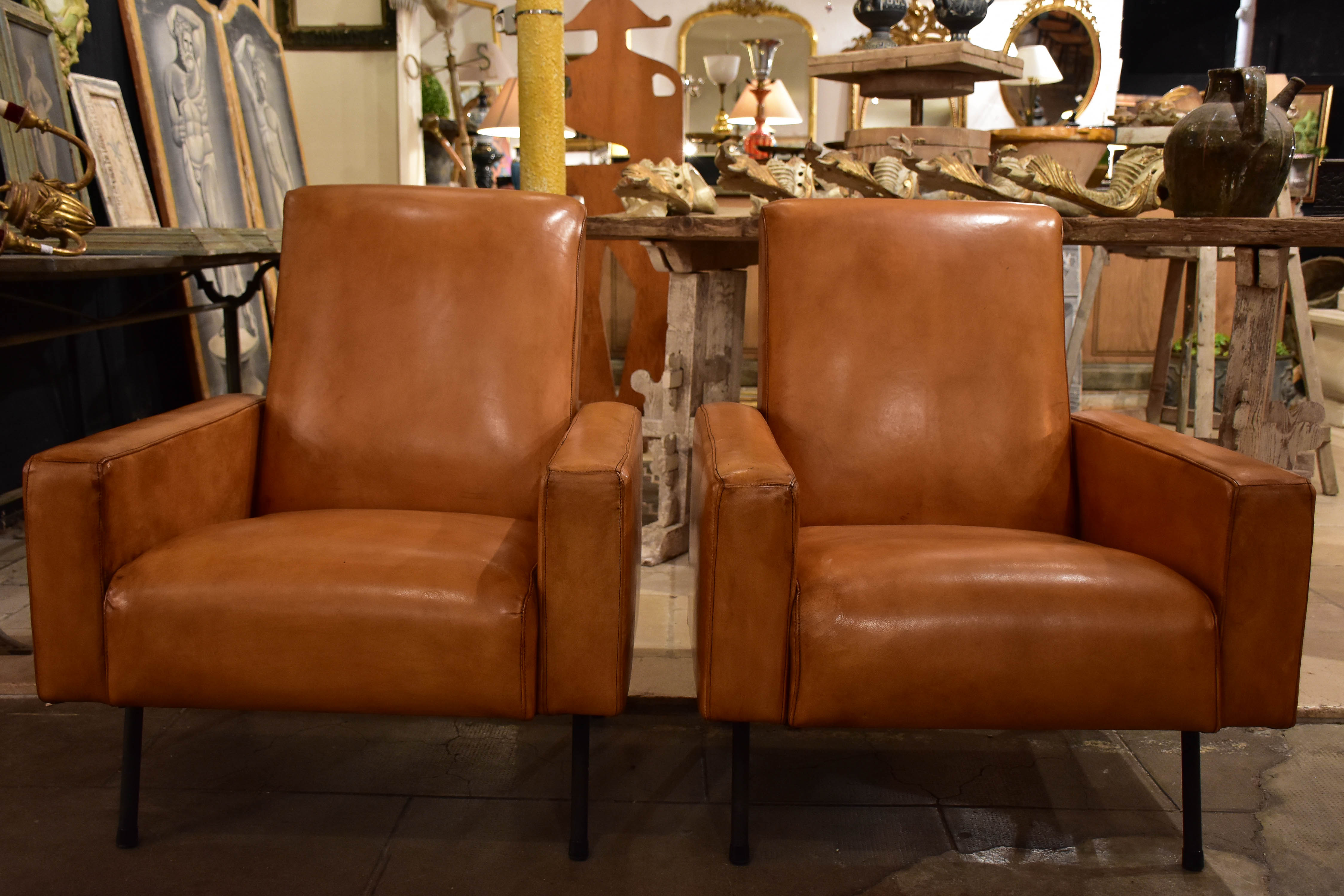 Pair of French leather armchairs in the style of Pierre Guariche