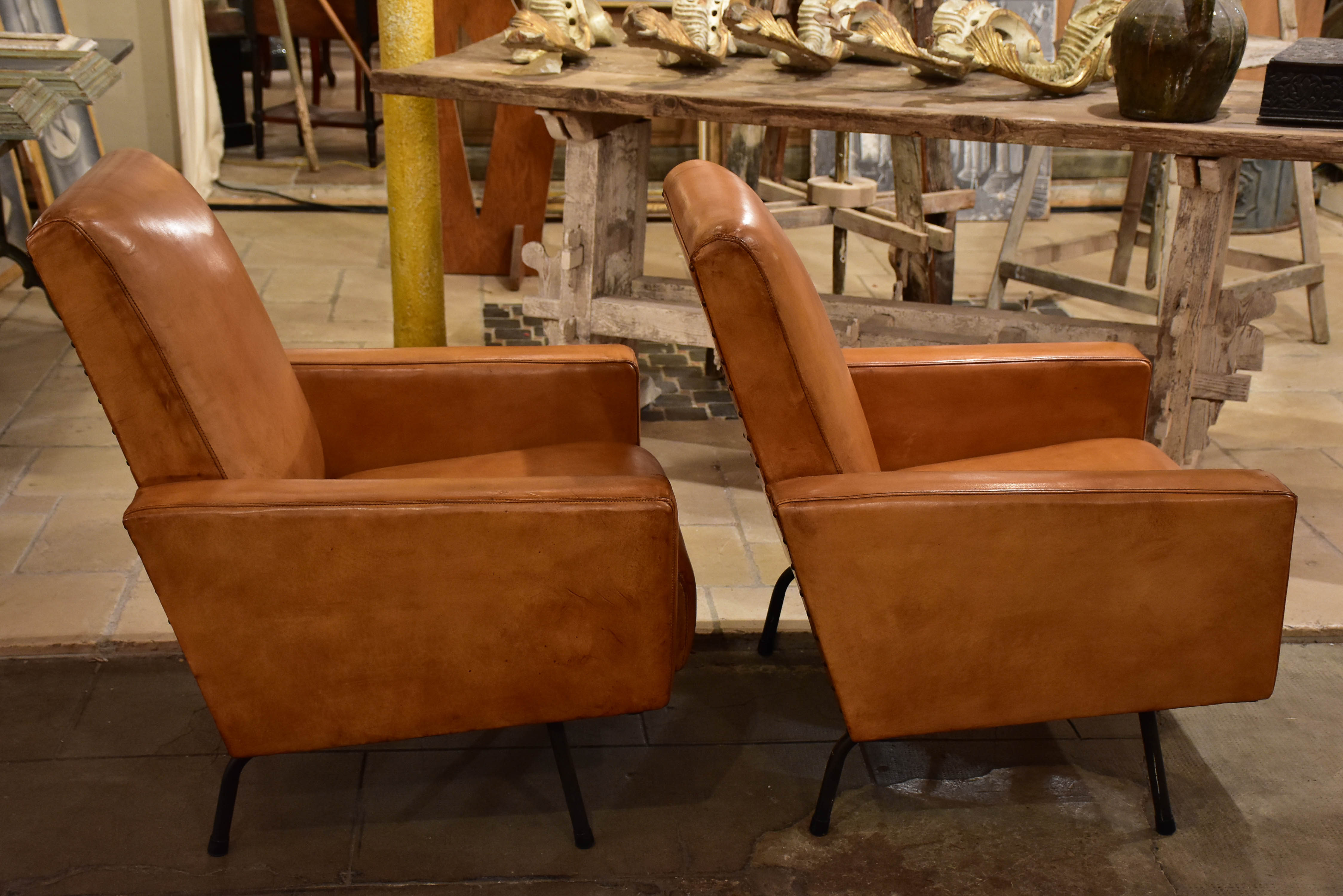 Pair of French leather armchairs in the style of Pierre Guariche