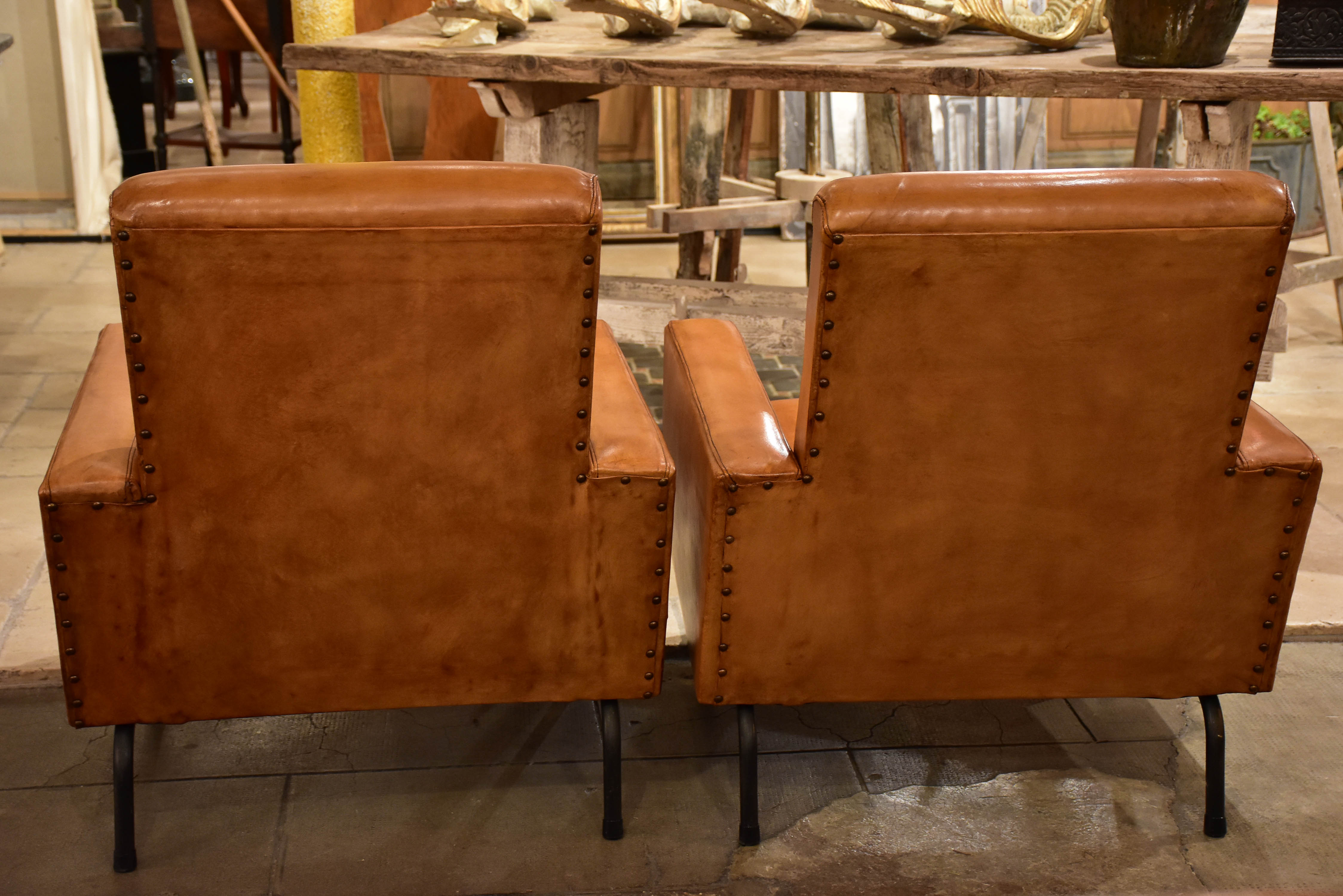 Pair of French leather armchairs in the style of Pierre Guariche