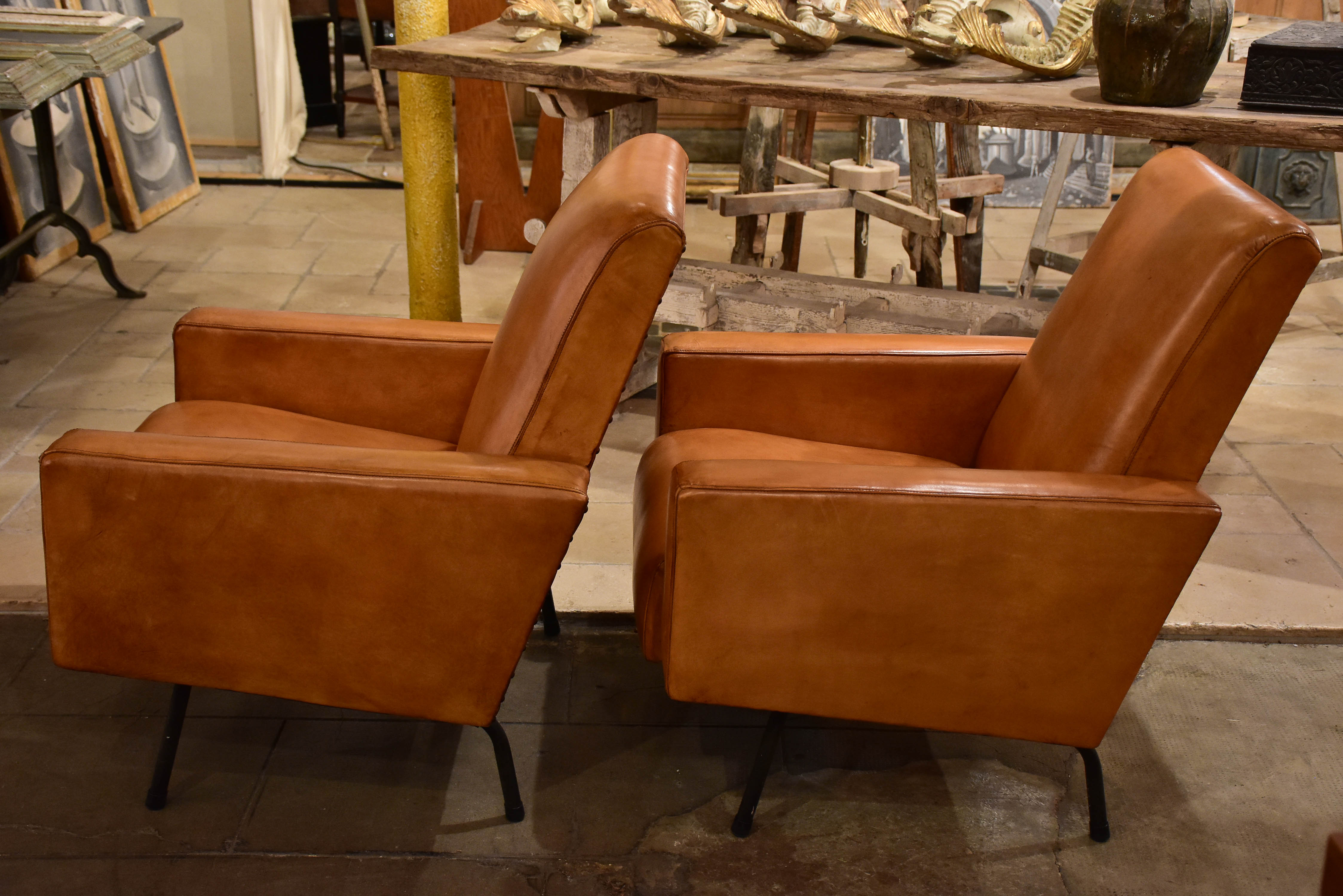 Pair of French leather armchairs in the style of Pierre Guariche