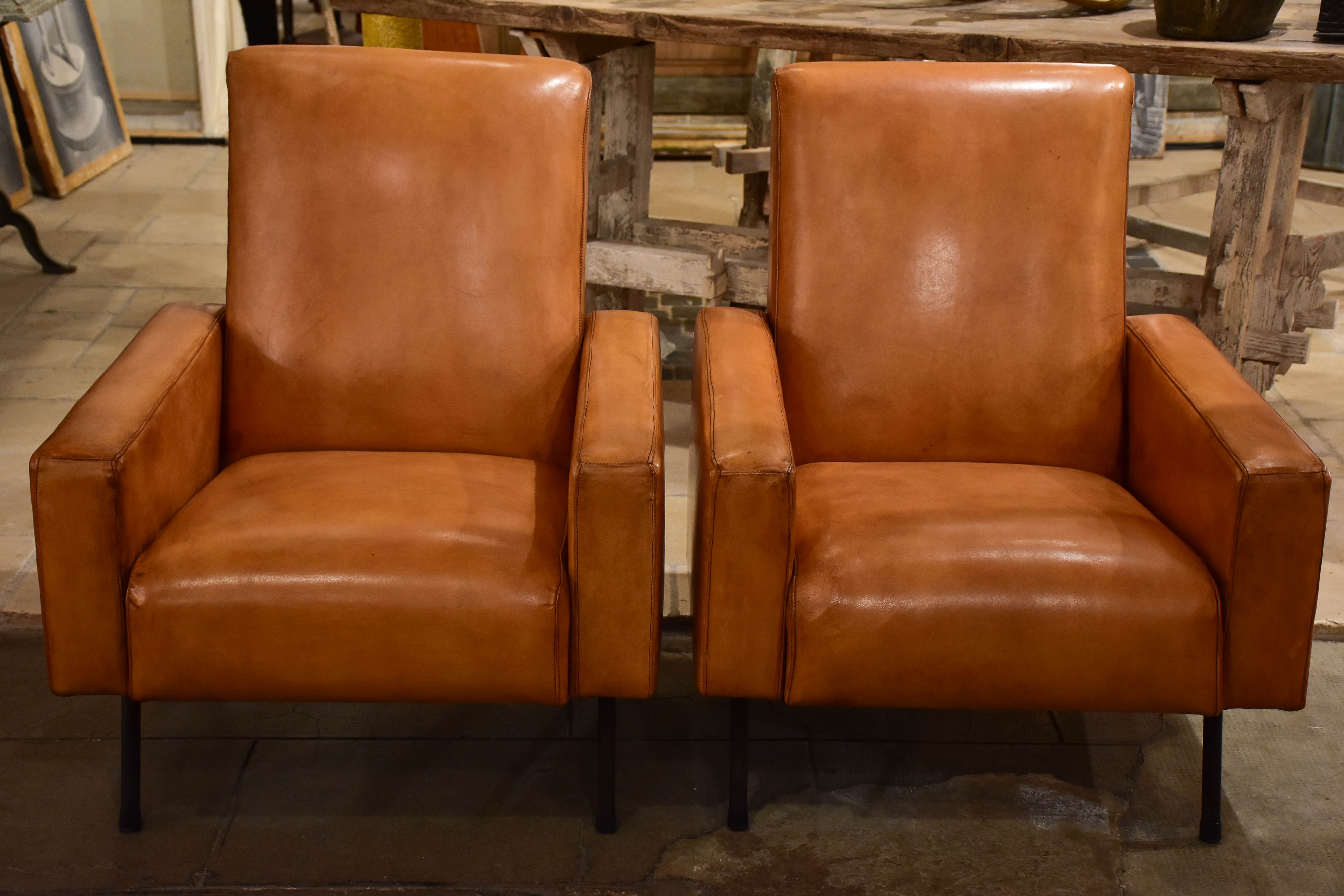 Pair of French leather armchairs in the style of Pierre Guariche