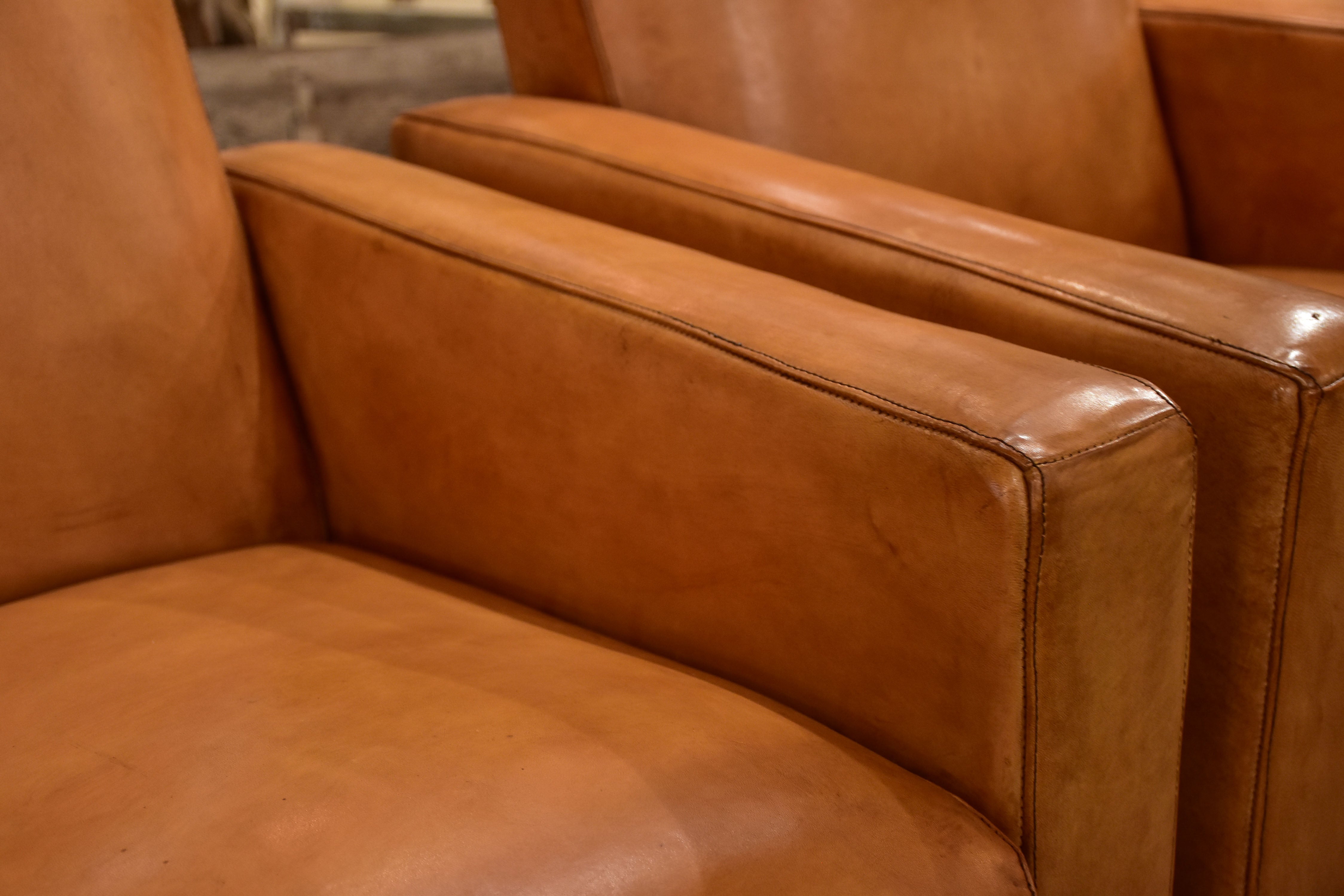 Pair of French leather armchairs in the style of Pierre Guariche