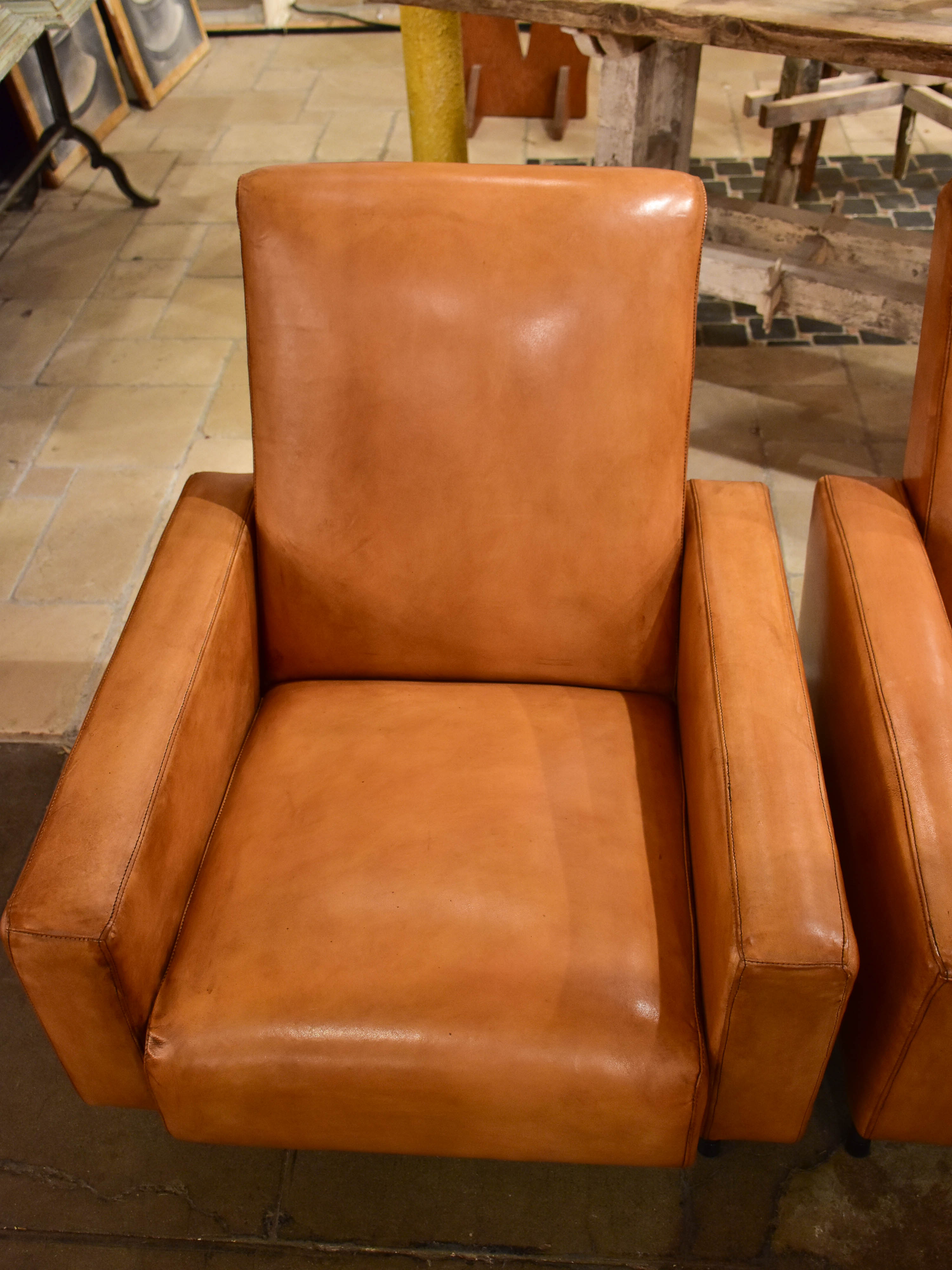 Pair of French leather armchairs in the style of Pierre Guariche