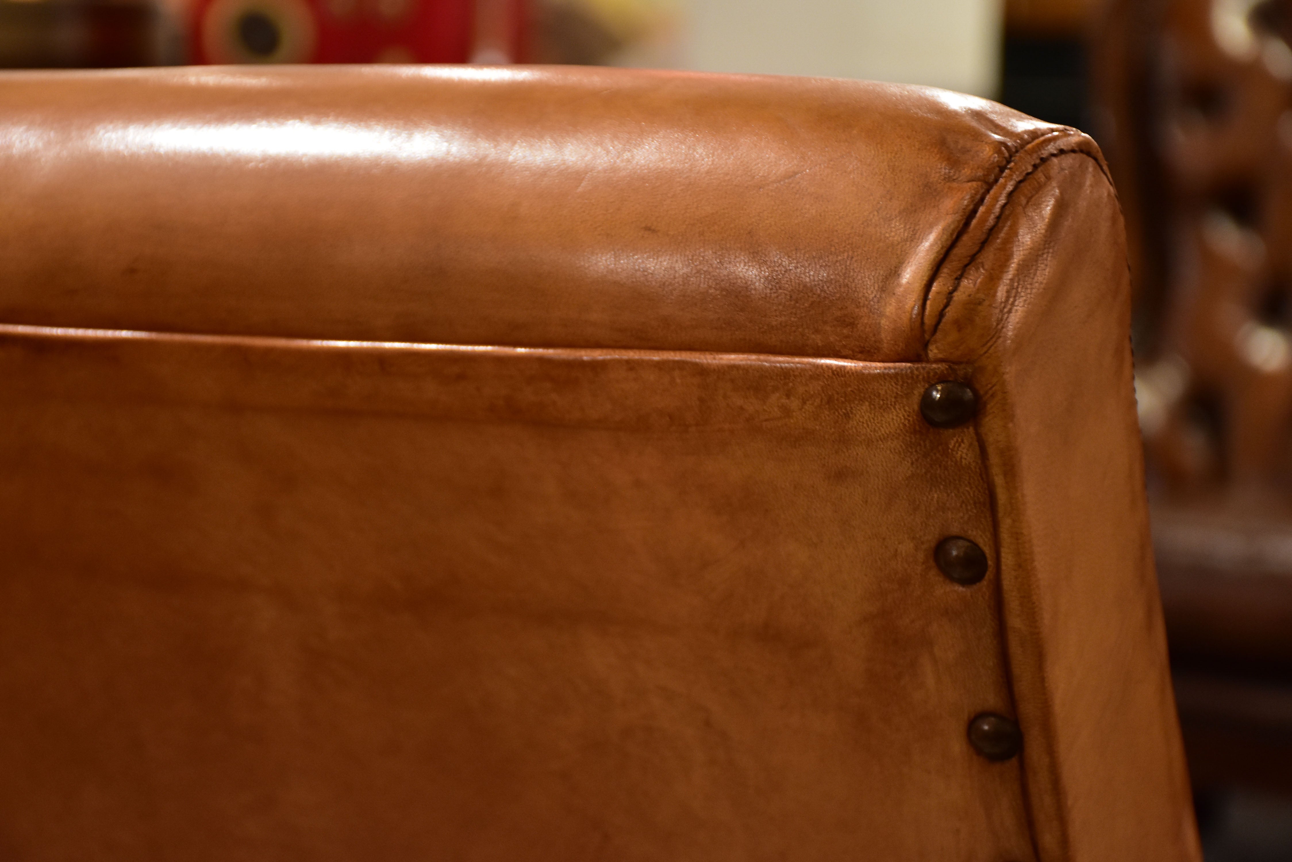 Pair of French leather armchairs in the style of Pierre Guariche