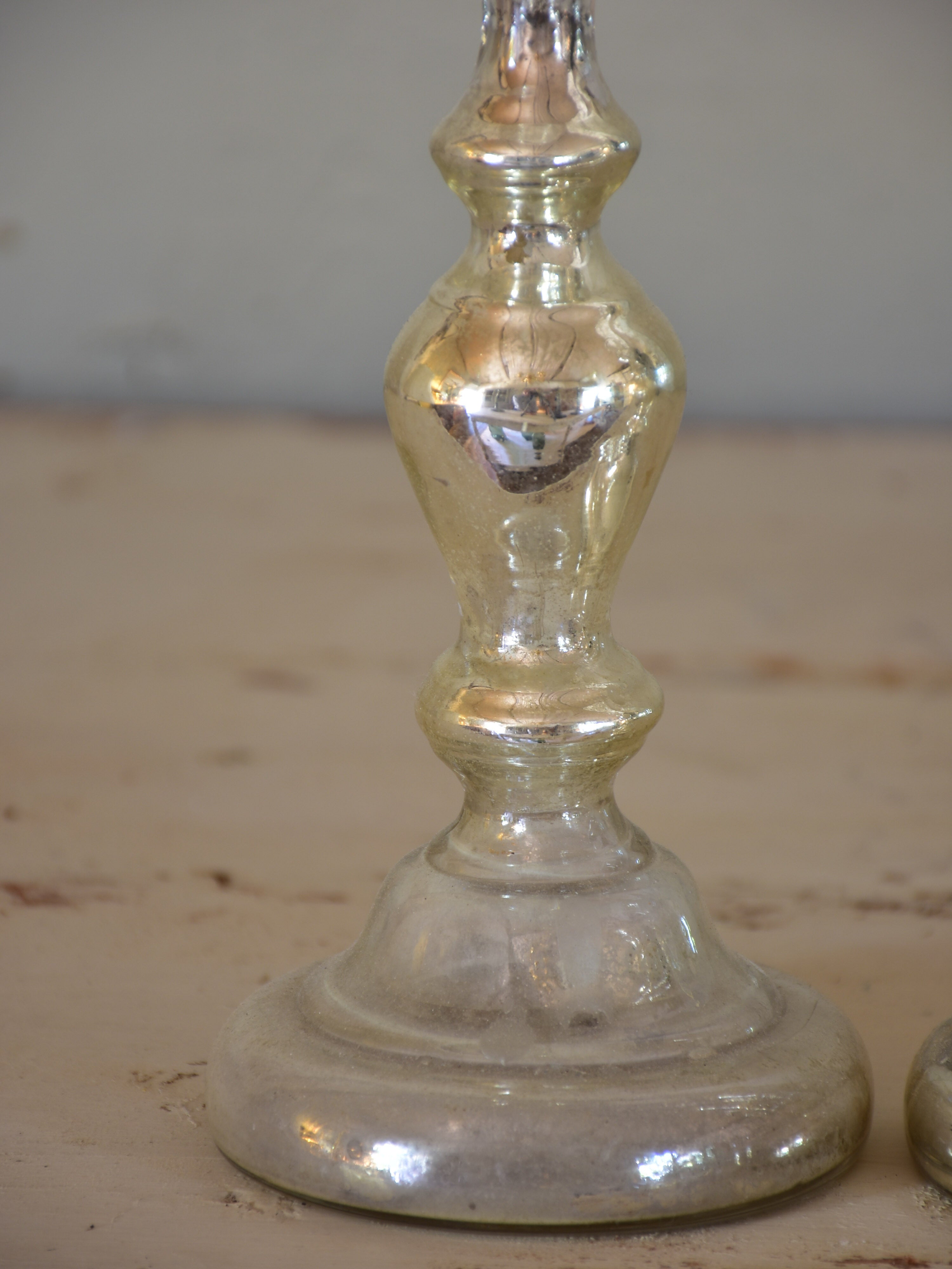 Two antique candlesticks, rustic mercury glass