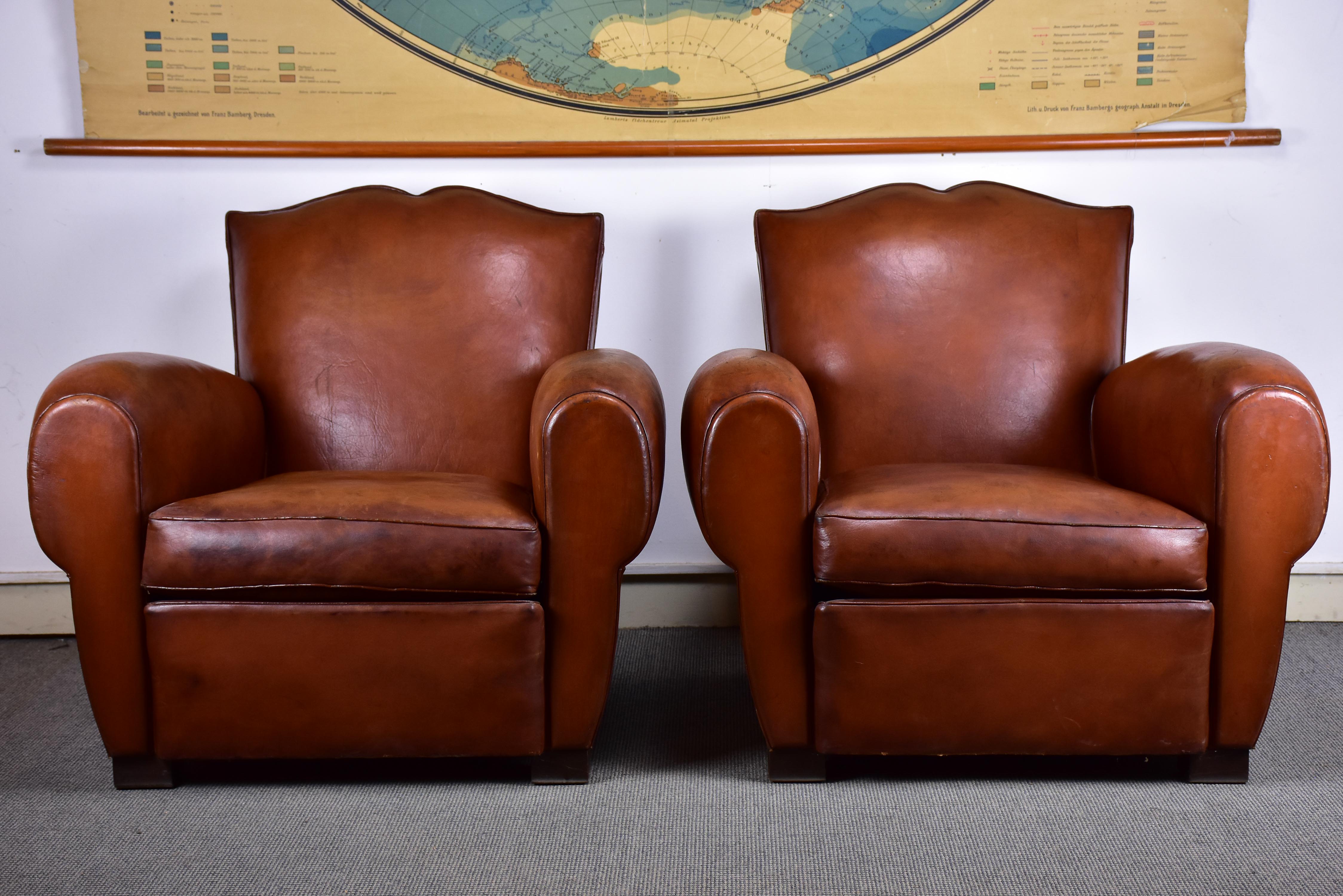 Pair of moustache back French leather club chairs