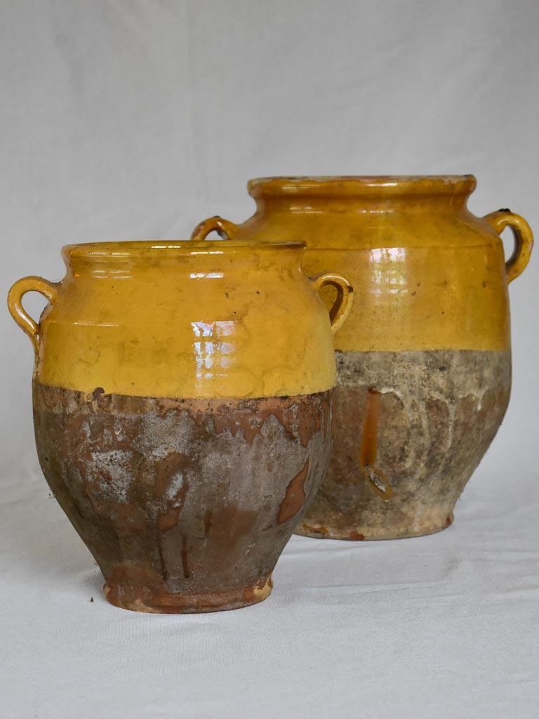 Two large antique French confit pots with yellow glaze