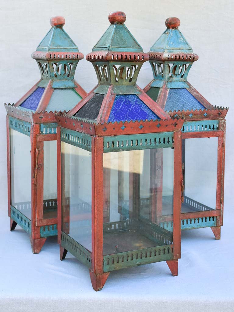 Three large lanterns with colored glass