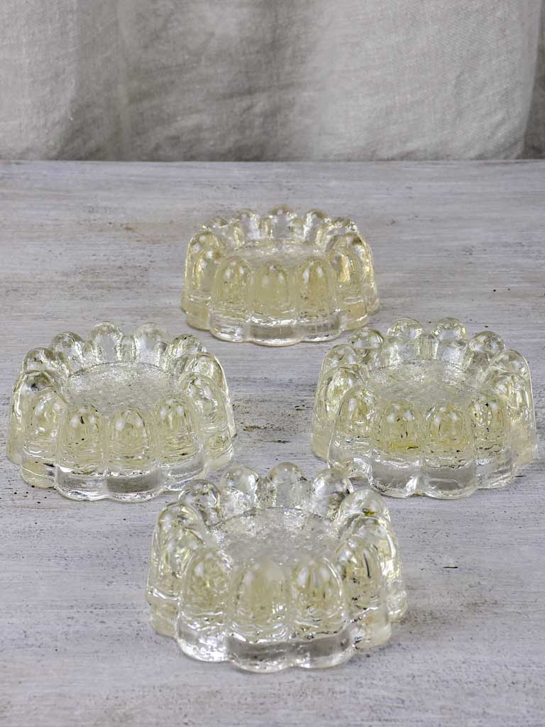 Four antique French glass table risers