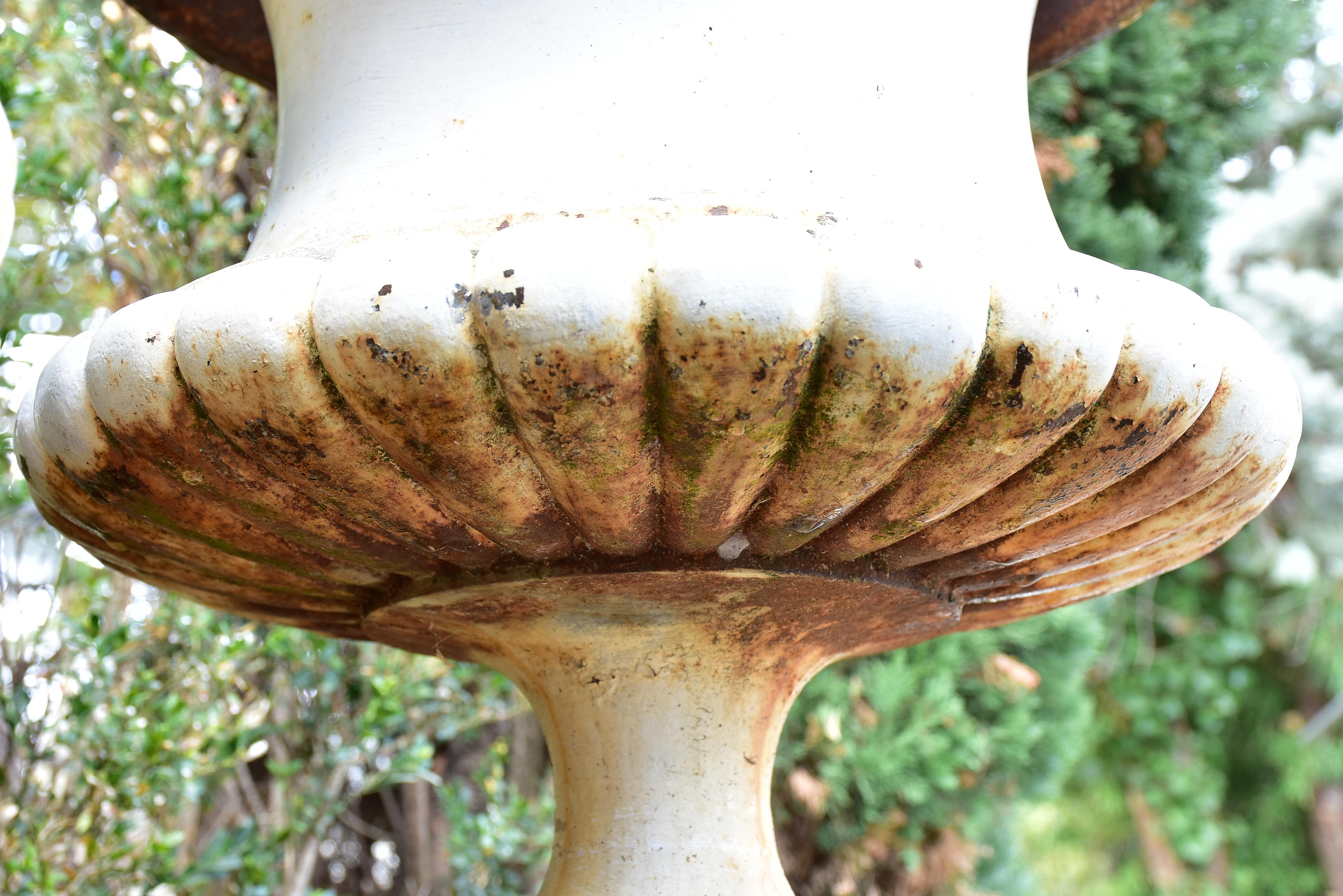 Two large antique French garden urns with white finish