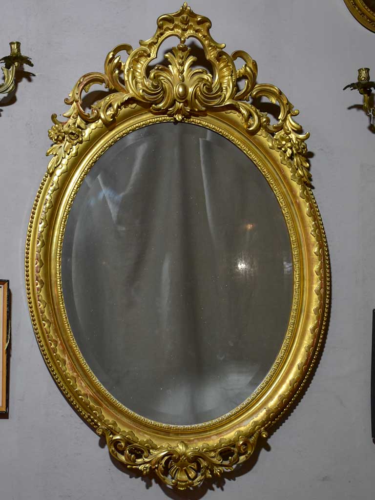 Very large oval French mirror with gilded frame and crest 32¼" x 48½"