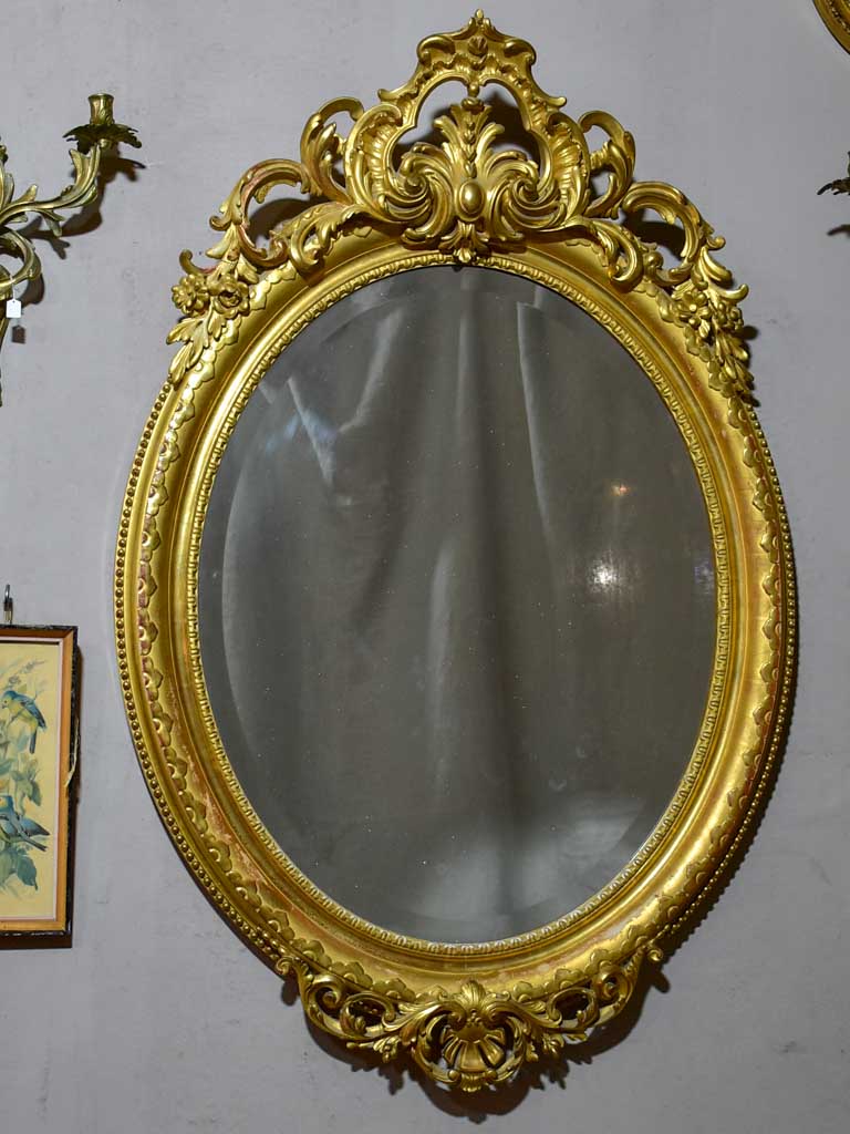 Very large oval French mirror with gilded frame and crest 32¼" x 48½"