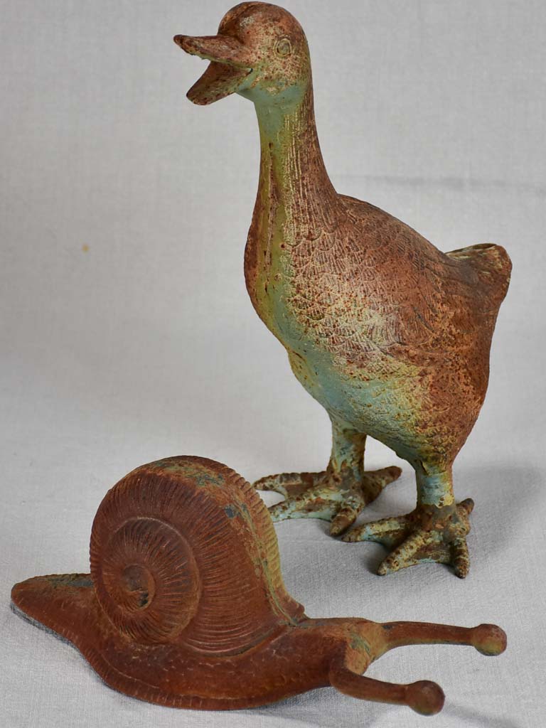 Vintage cast iron duck and oversized snail