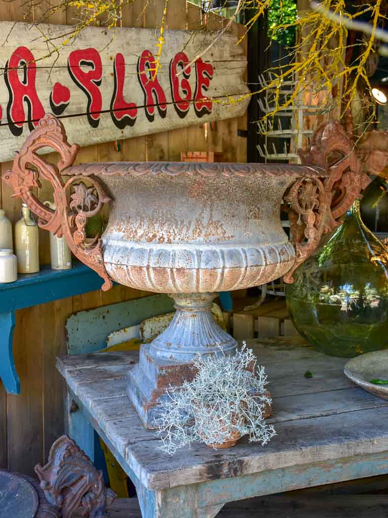 Pair of extra large antique French cast iron Medici urns with overarching handles