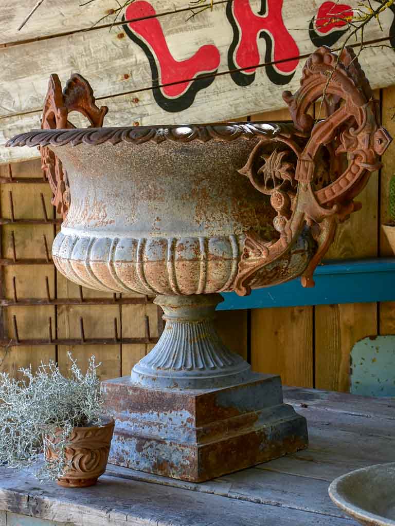 Pair of extra large antique French cast iron Medici urns with overarching handles