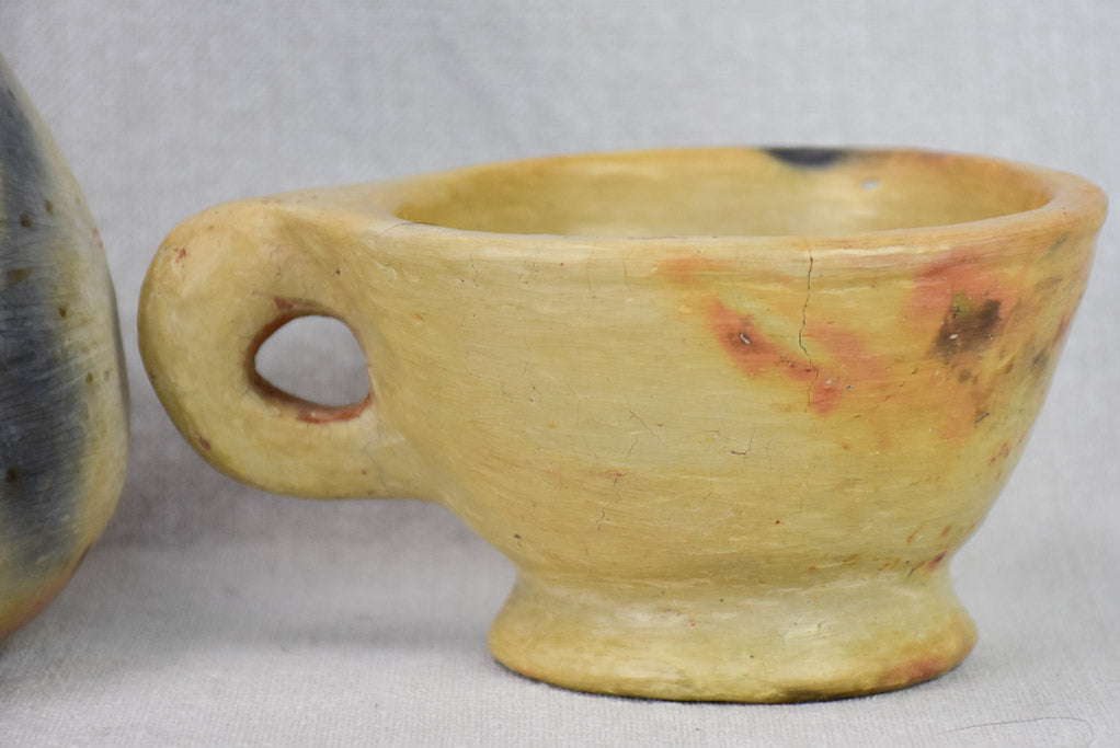 Two artisan-made ceramics made from wood-fired clay - vase and cup