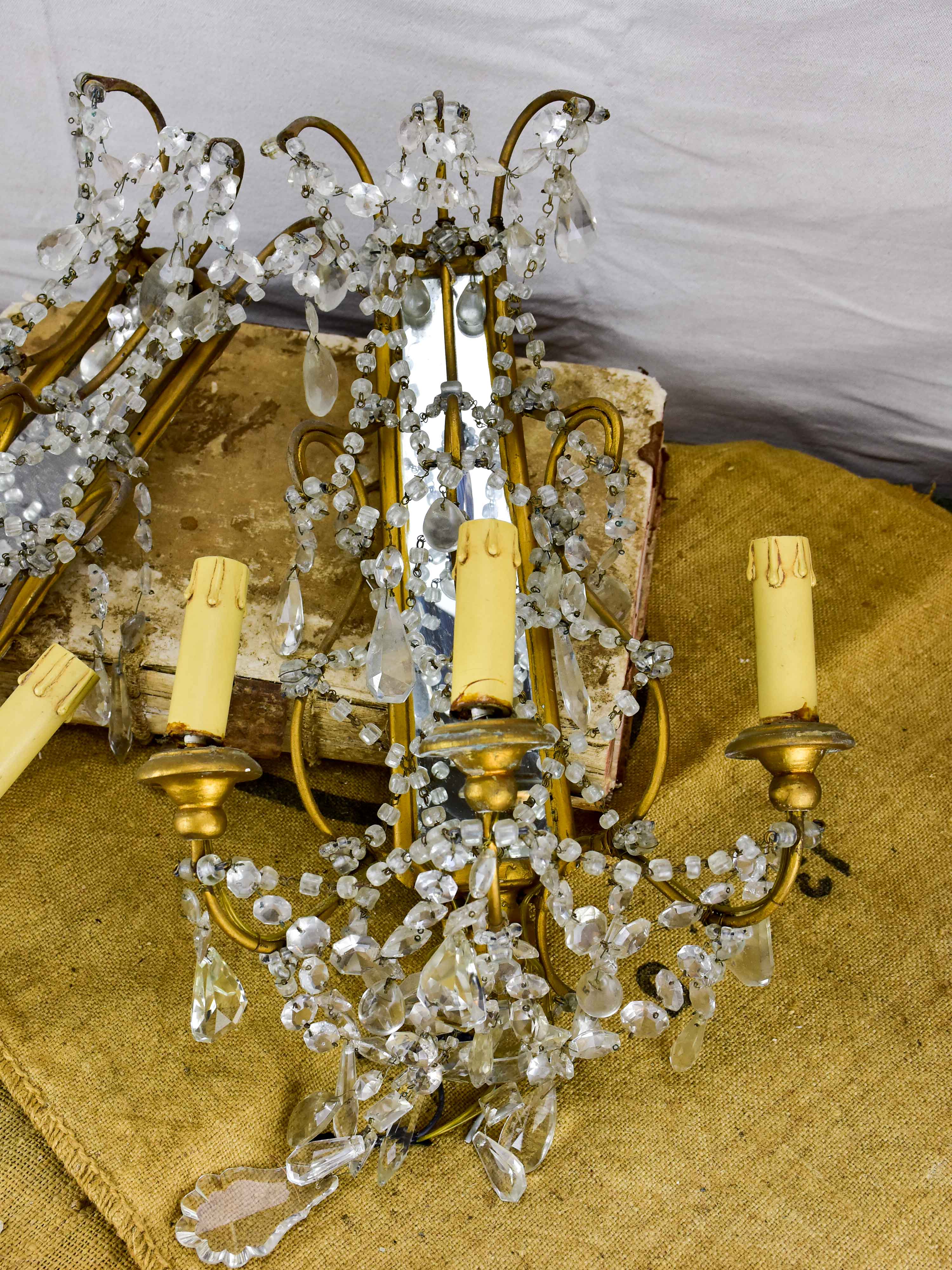 Pair of antique Italian wall sconces with pendants and mirrored backs