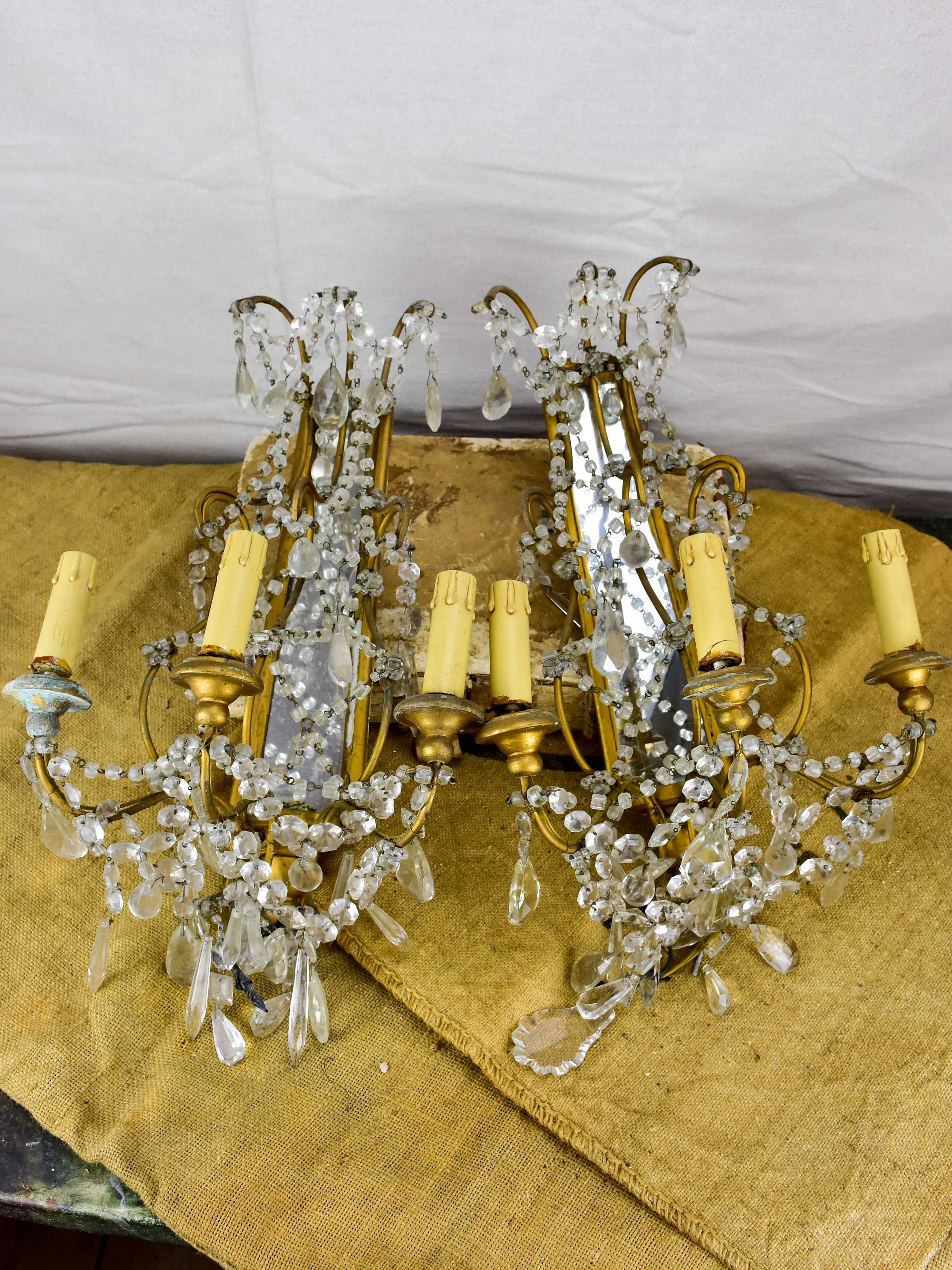 Pair of antique Italian wall sconces with pendants and mirrored backs