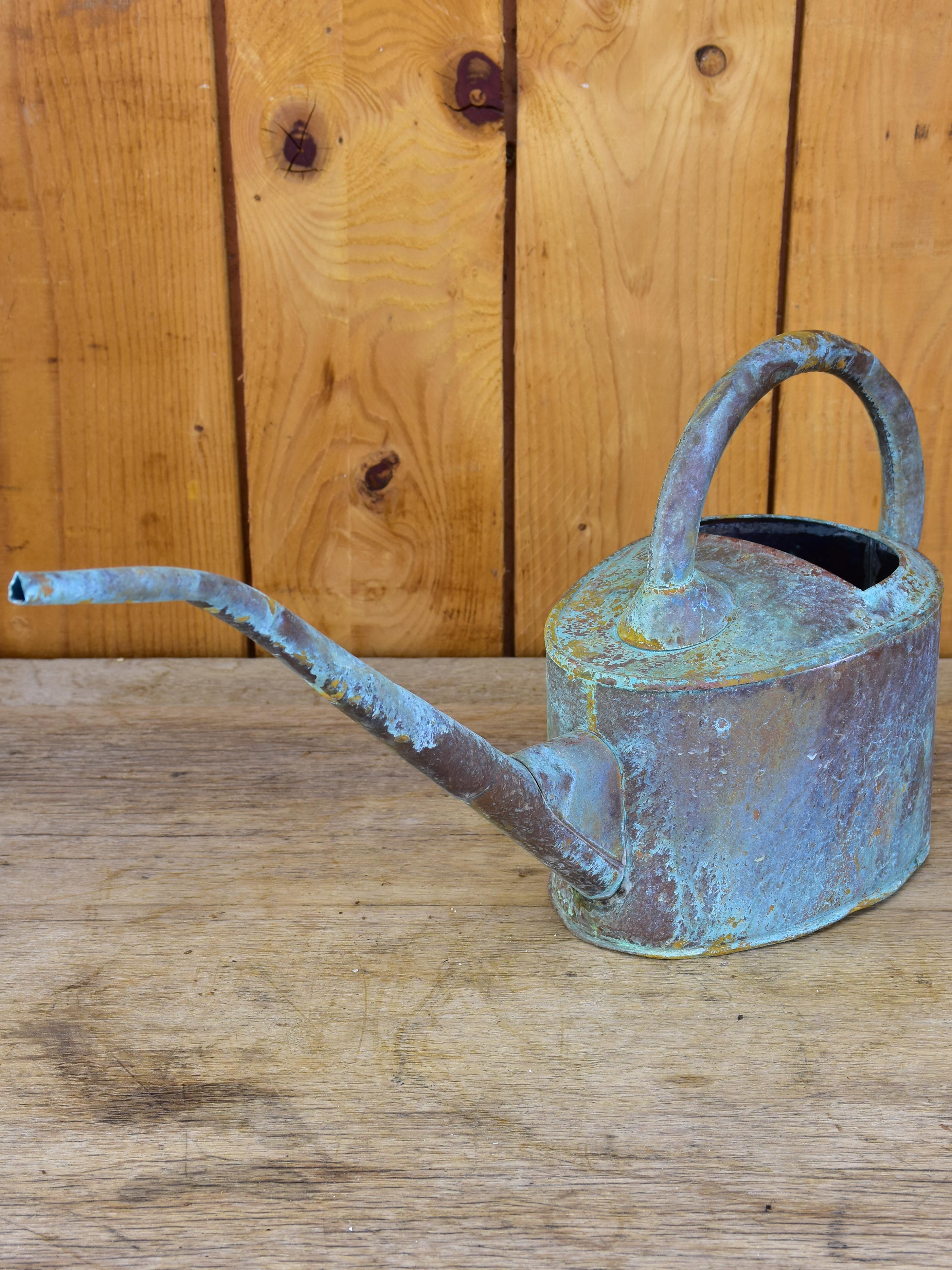 Small zinc watering can with long spout and blue patina