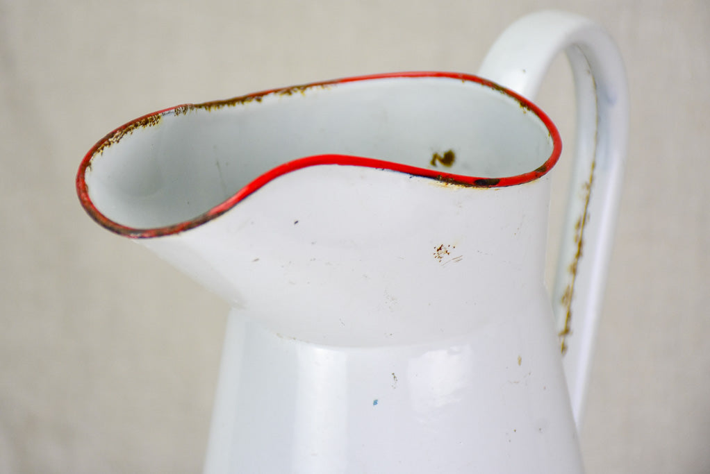 Mid century enamel pitcher - white with red rim 15"