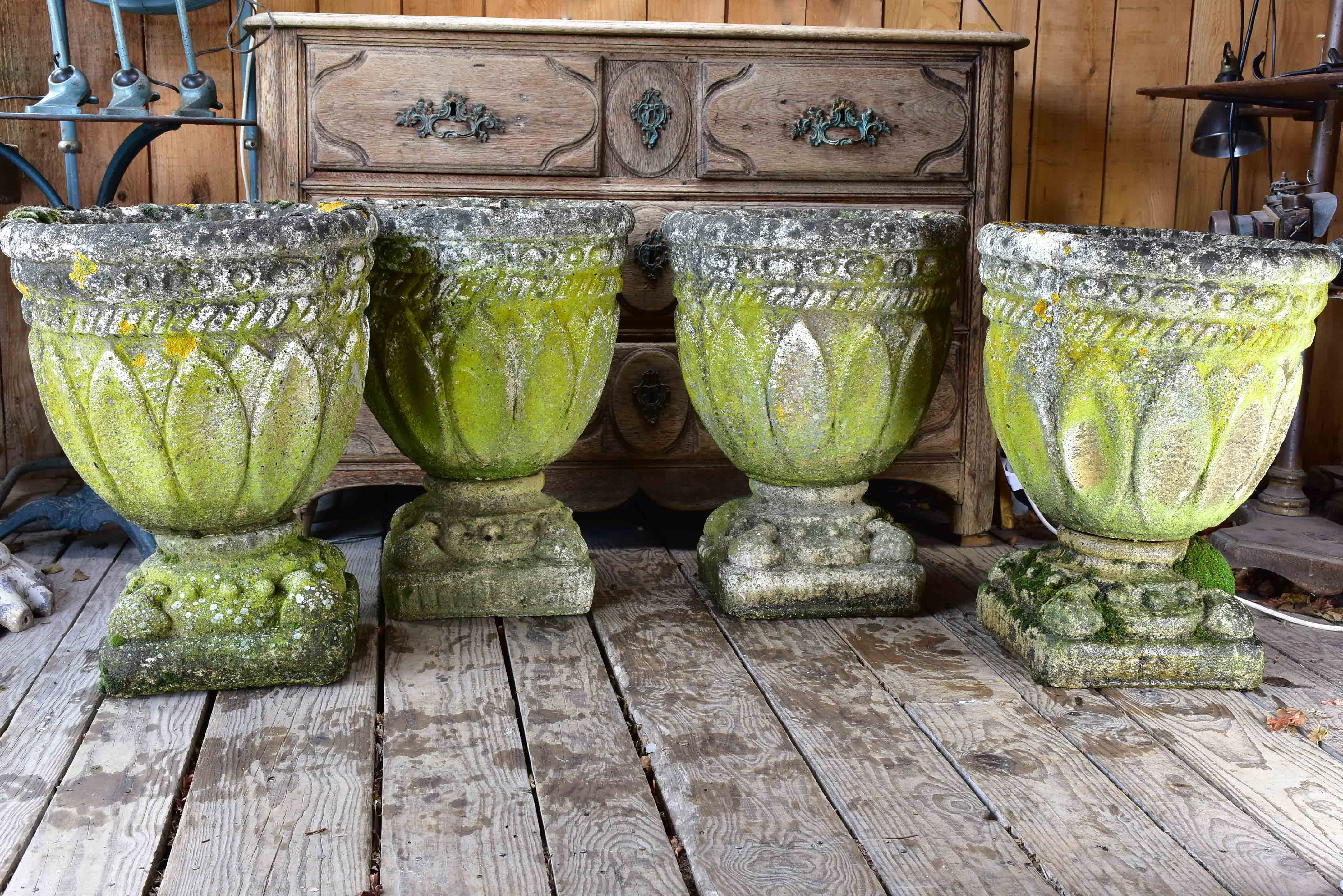 Four antique French garden pots on pedestals