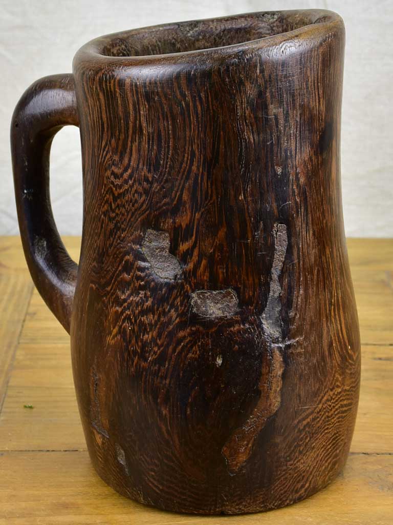 Primitive carved wooden pitcher