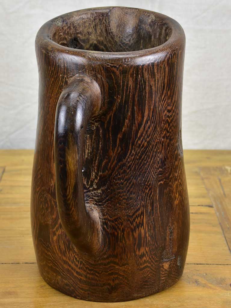 Primitive carved wooden pitcher