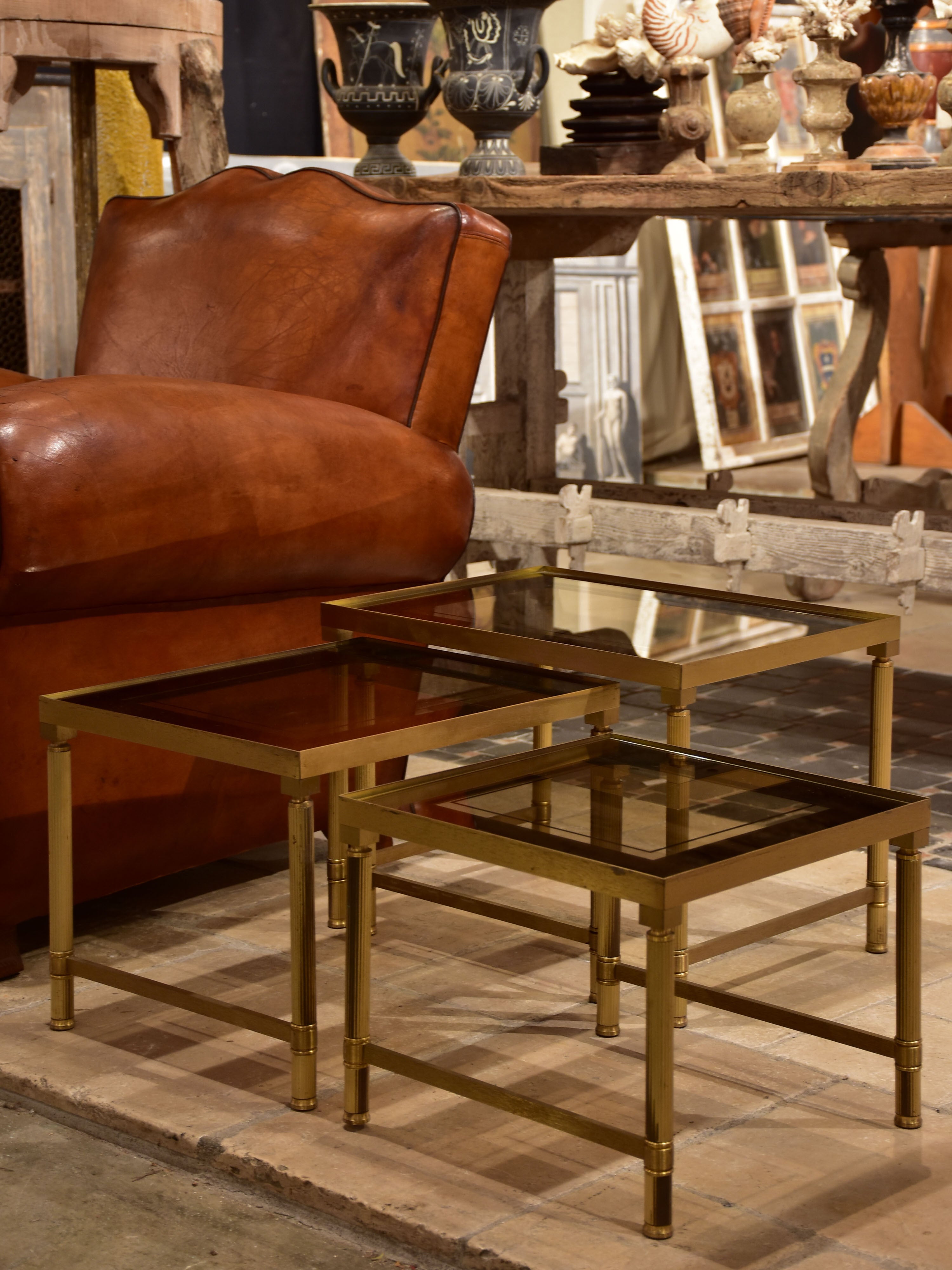 Set of three 1960s nesting tables in brass and tinted glass