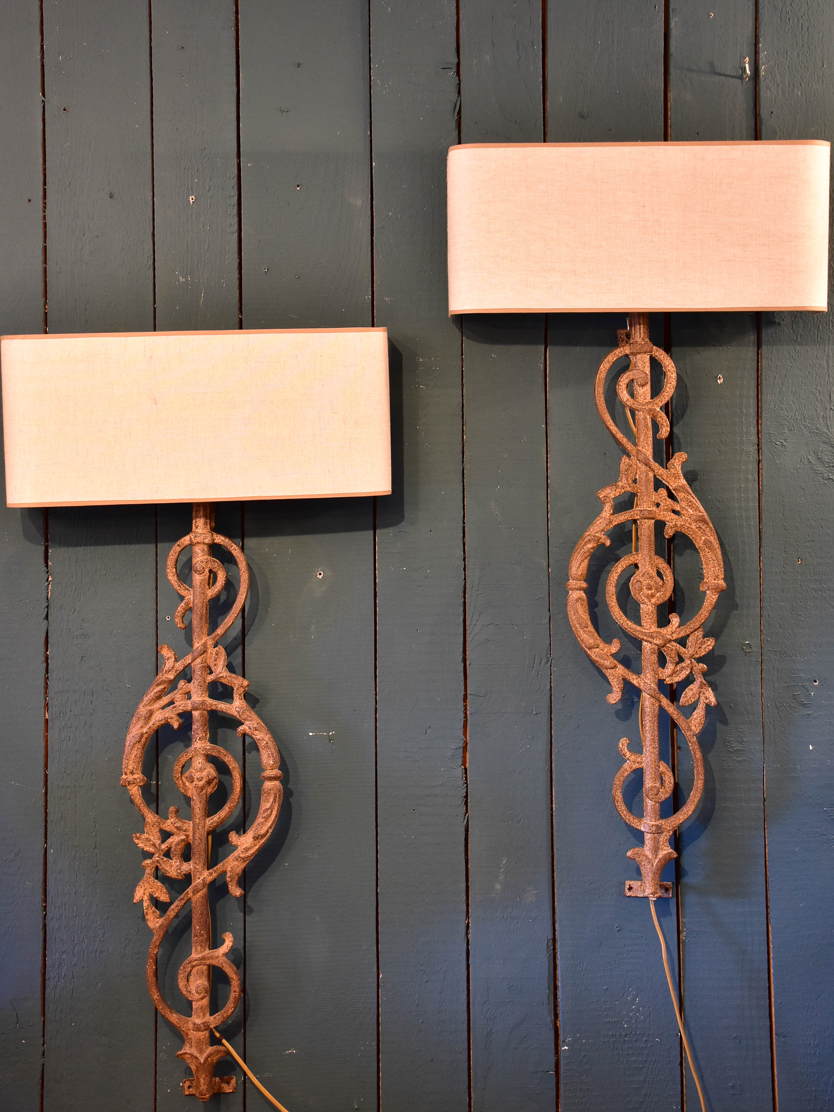 Pair of wall sconces made from salvaged iron from a balcony