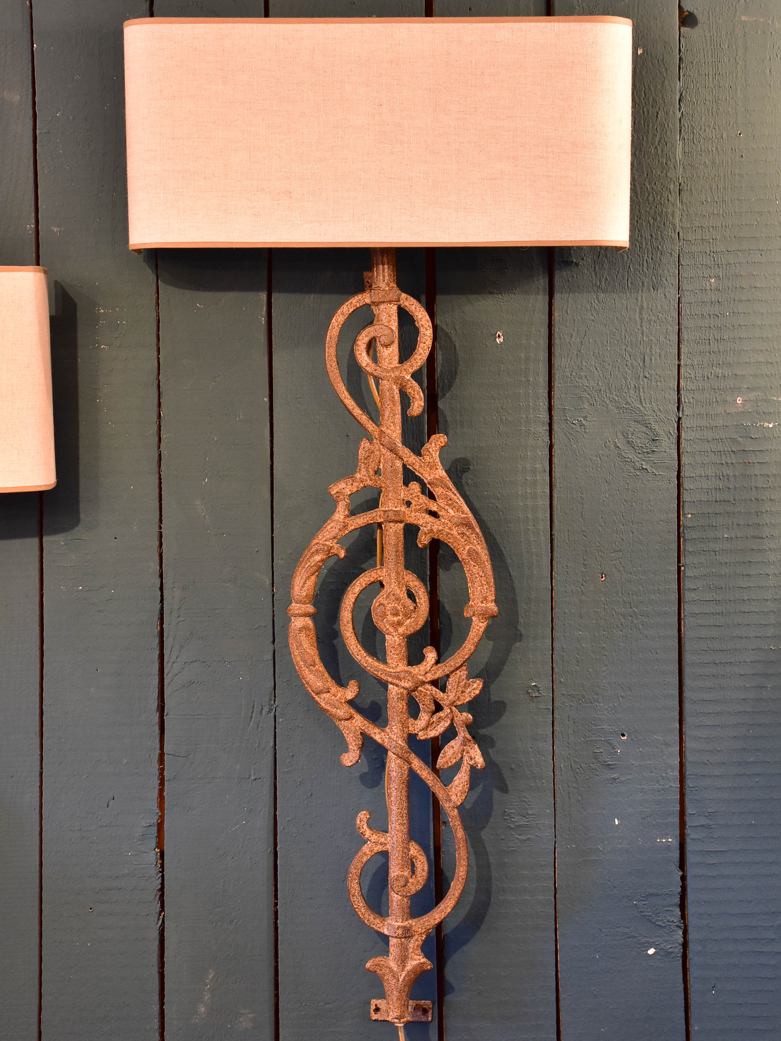 Pair of wall sconces made from salvaged iron from a balcony