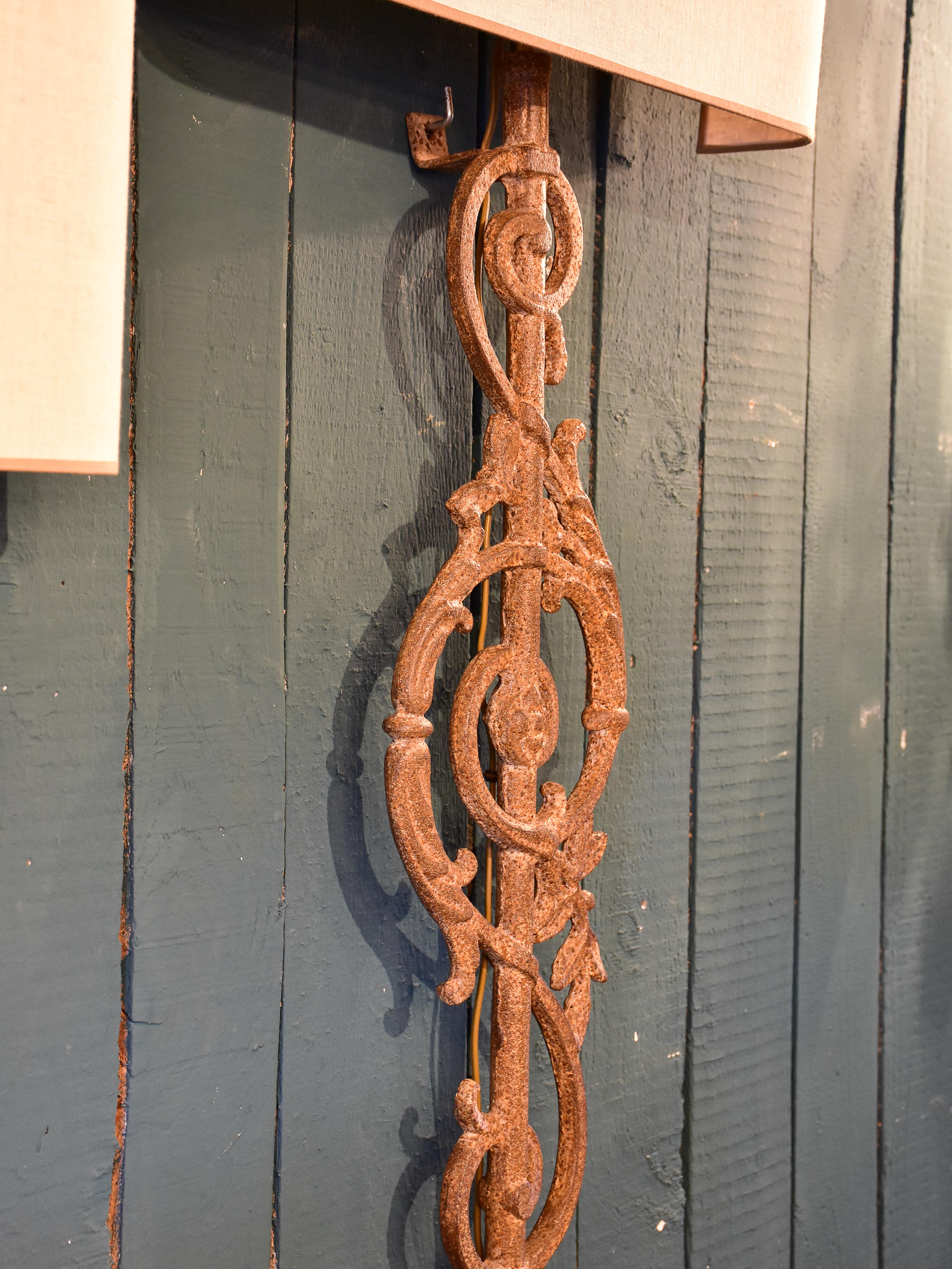 Pair of wall sconces made from salvaged iron from a balcony