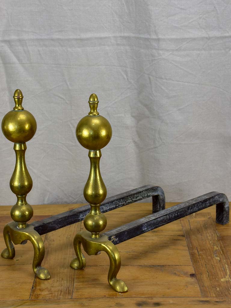 Pair of antique French andirons in brass and iron