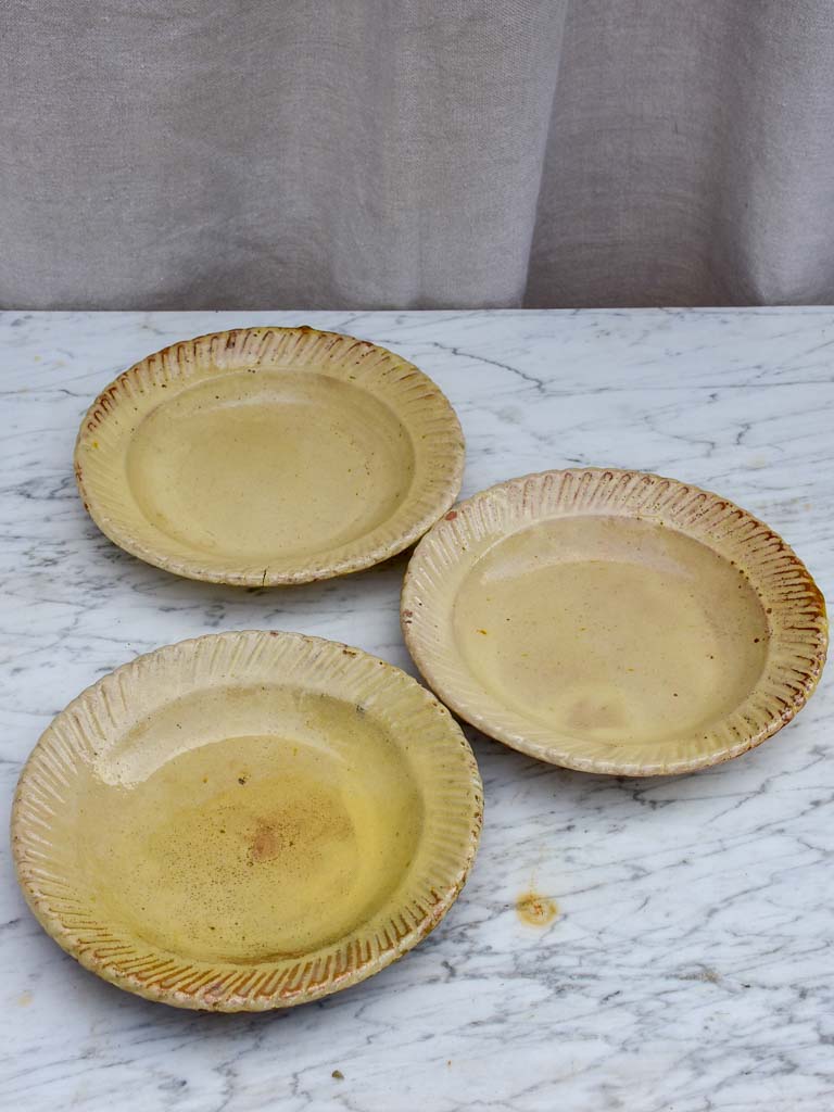 Three antique French yellow ware plates with pretty border