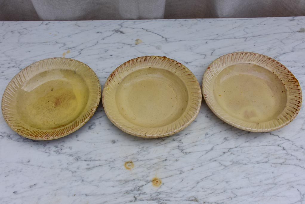 Three antique French yellow ware plates with pretty border