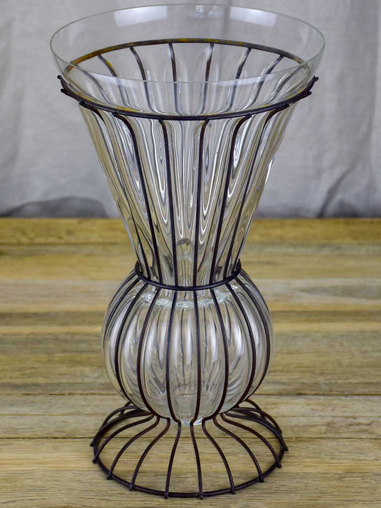 Tall blown glass vase in metal frame