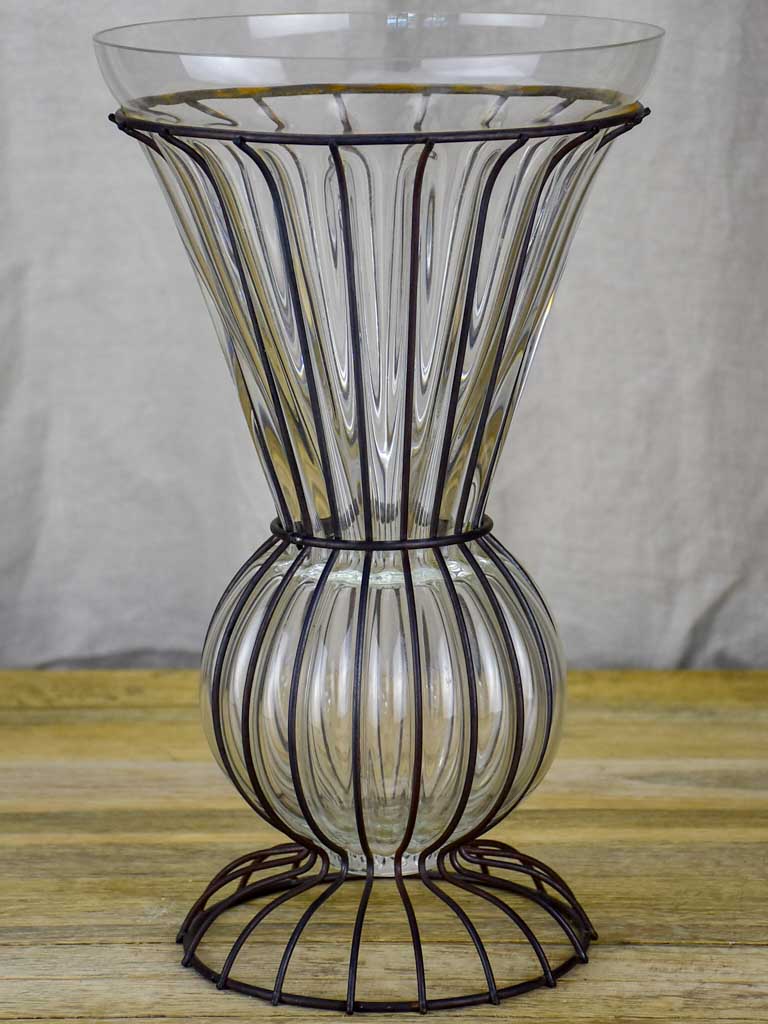 Tall blown glass vase in metal frame