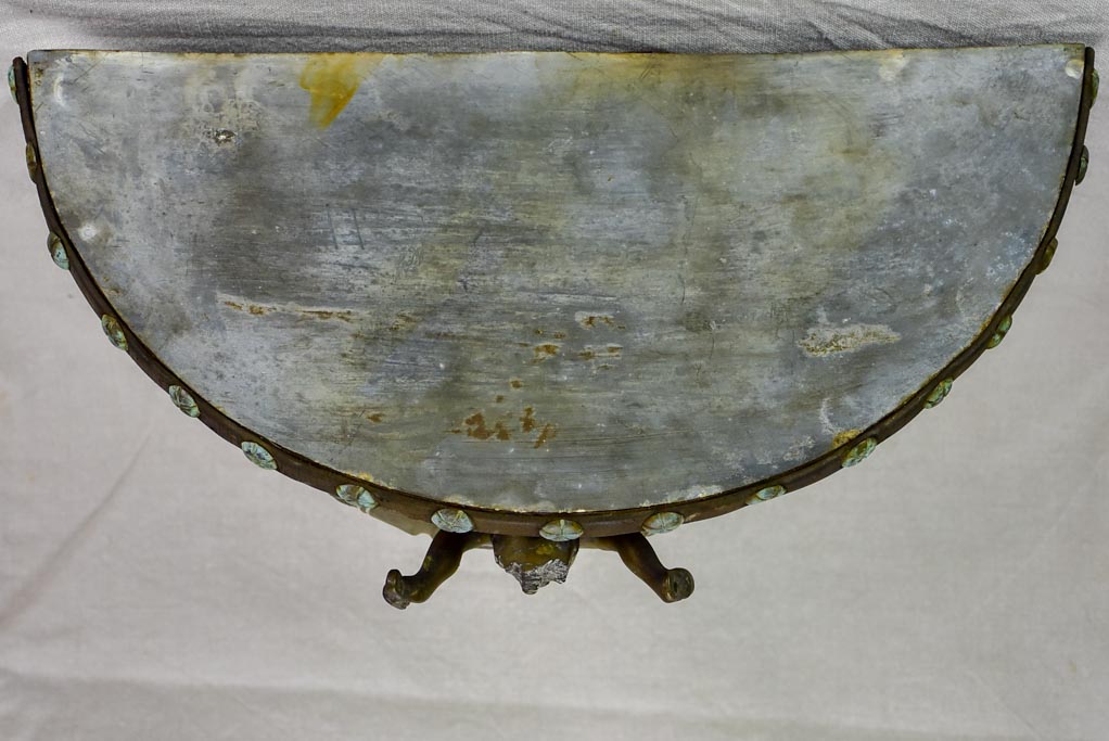 Antique French floating metal console with cherub