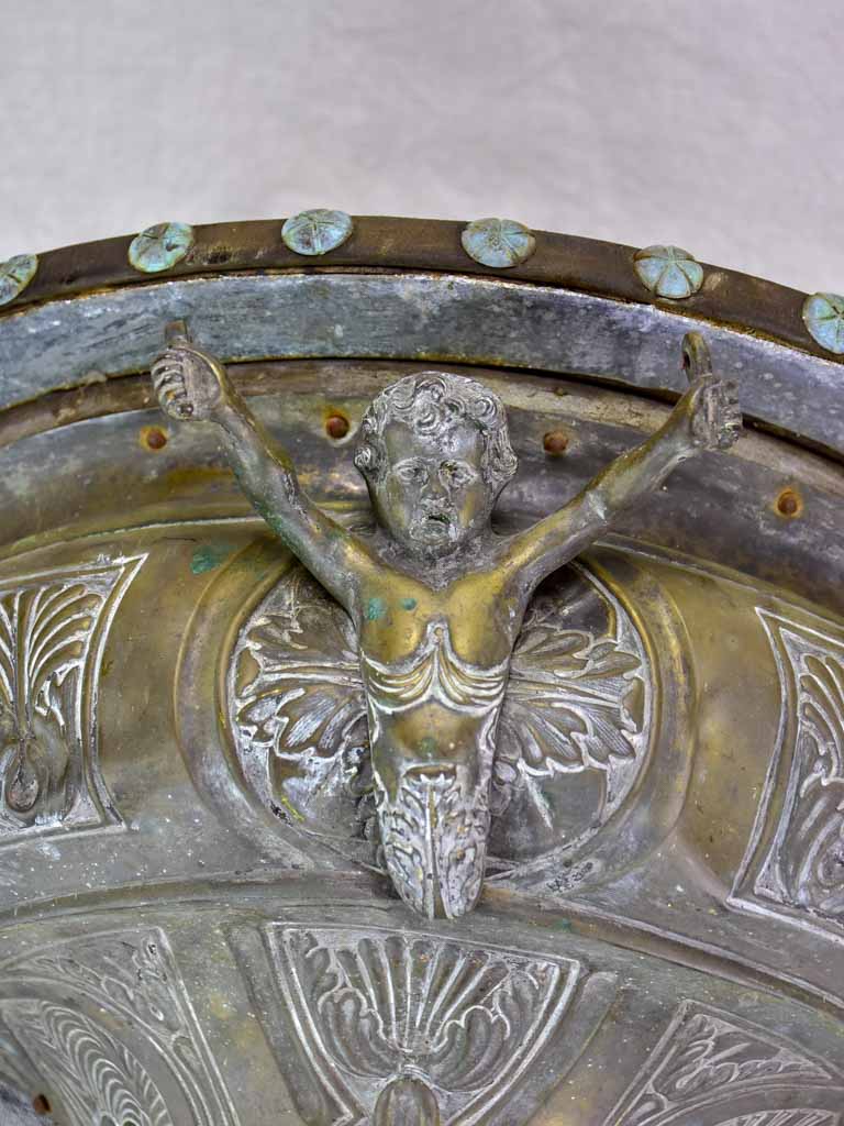 Antique French floating metal console with cherub